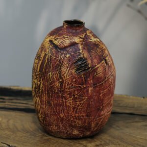 Single handmade ceramic vase with natural texture and organic form, viewed frontally