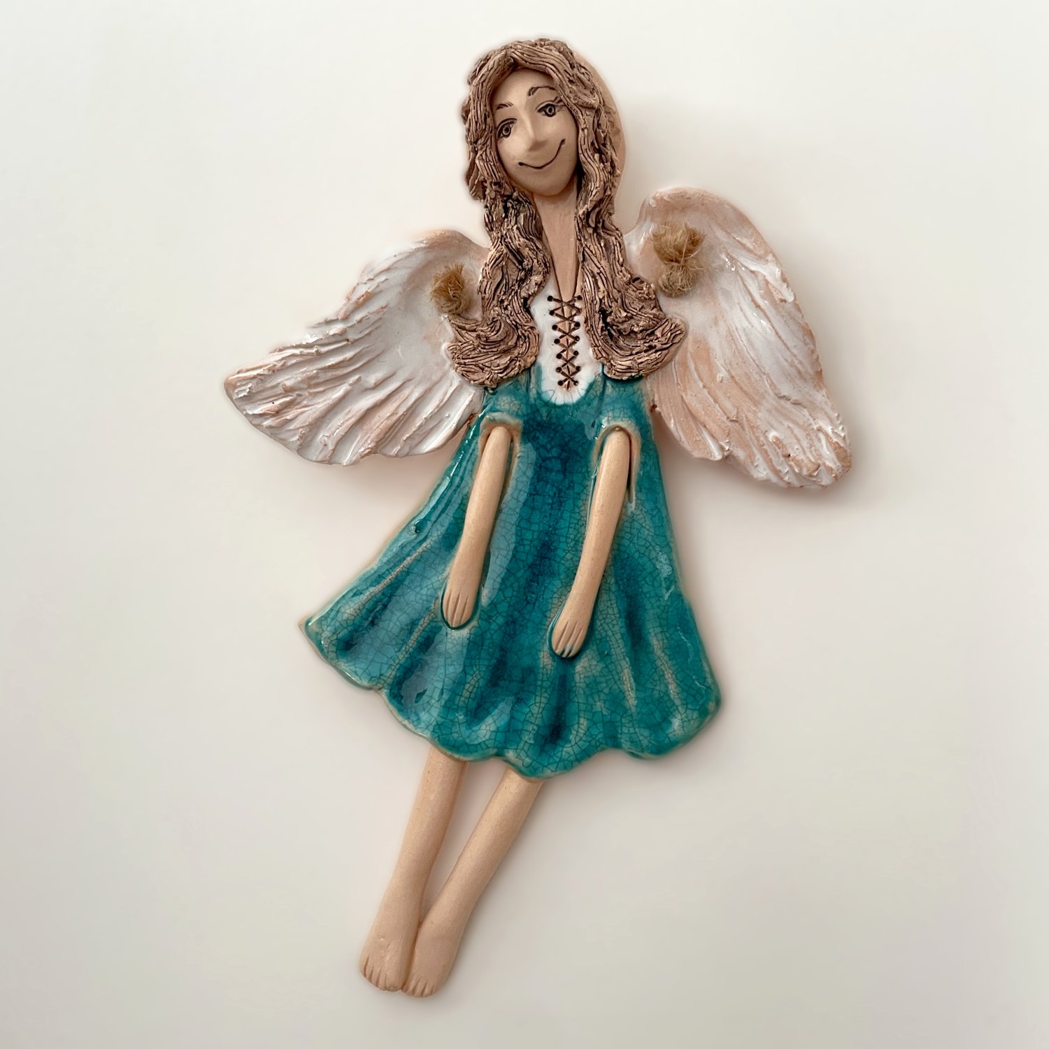 Handmade ceramic angel wall sculpture with turquoise dress and white wings