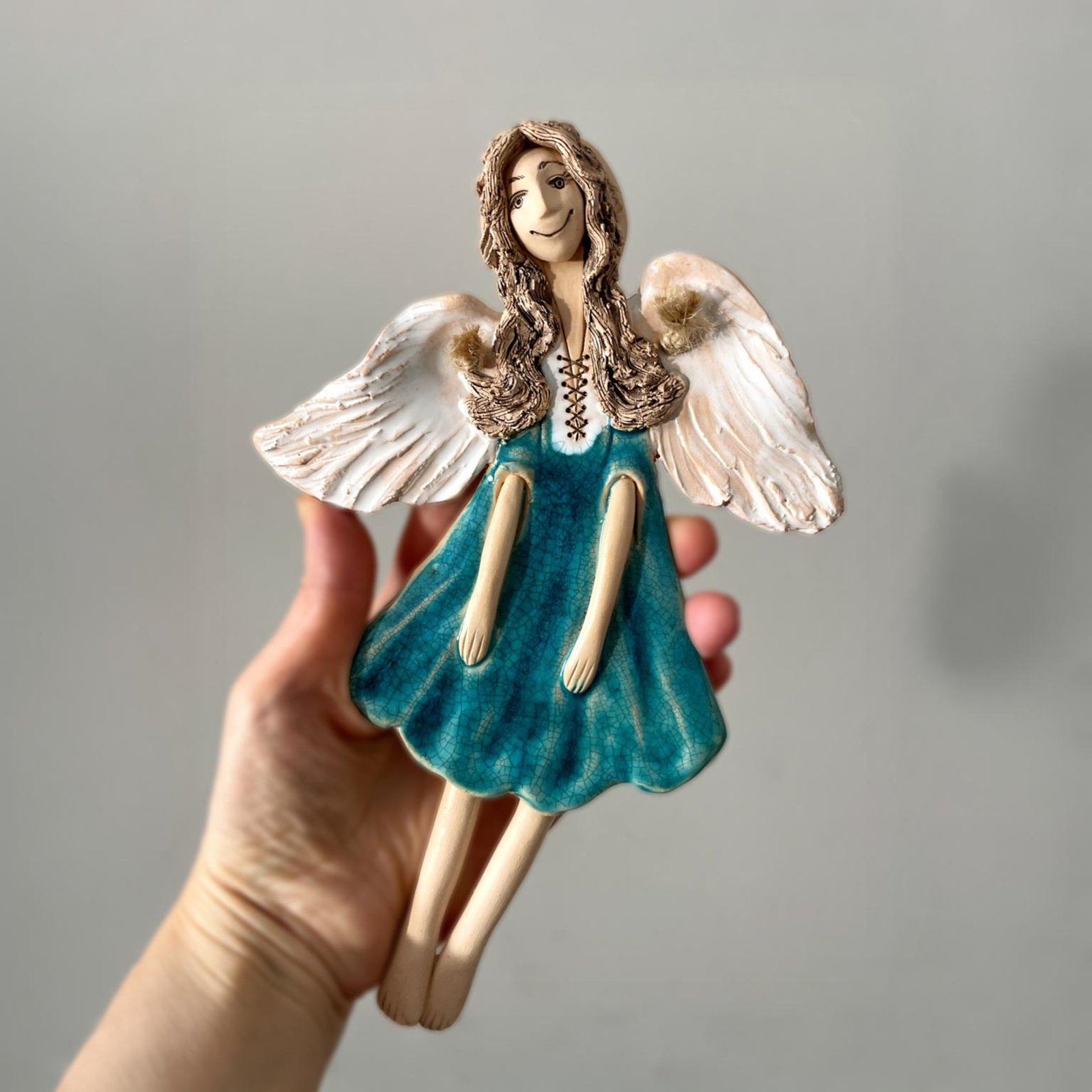 Hand sculpted ceramic angel with textured turquoise glaze