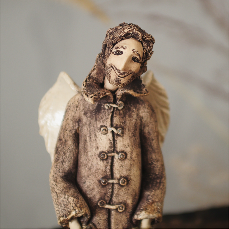 Male guardian angel ceramic sculpture detail