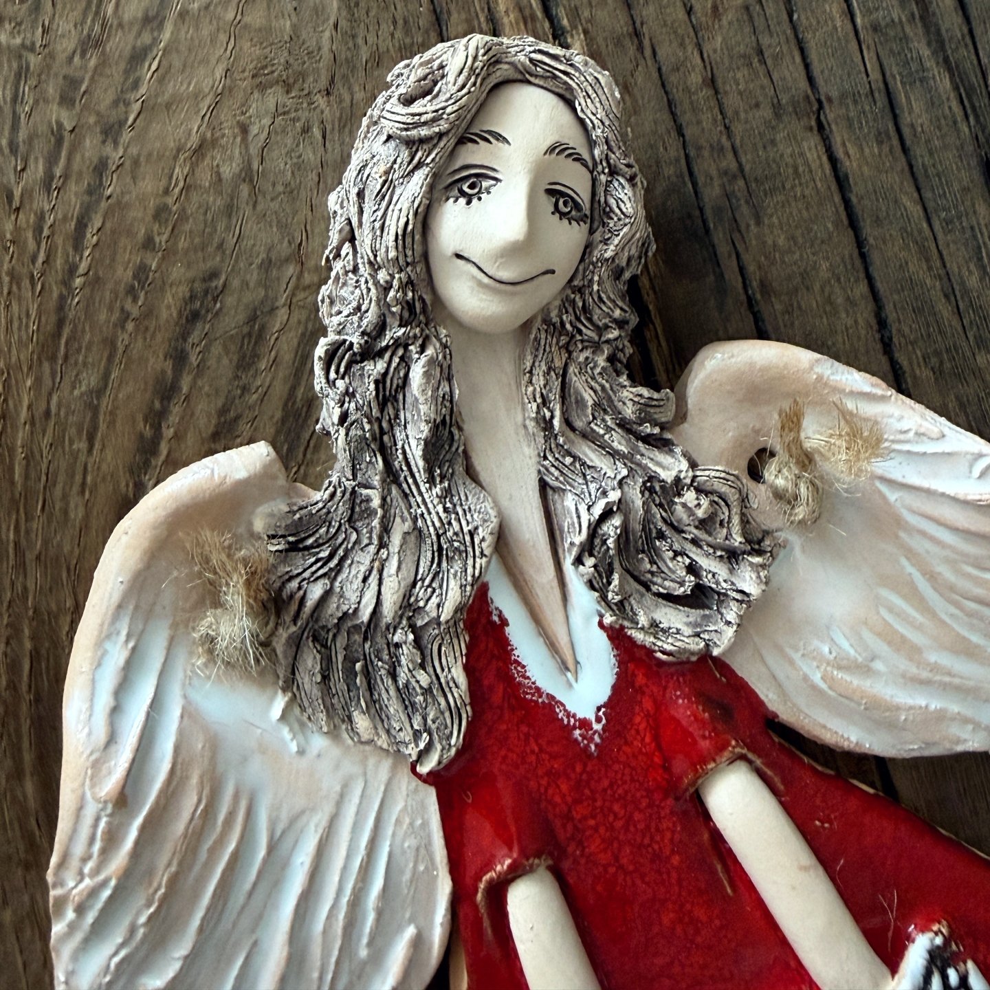 Handmade ceramic angel with white wings and red dress