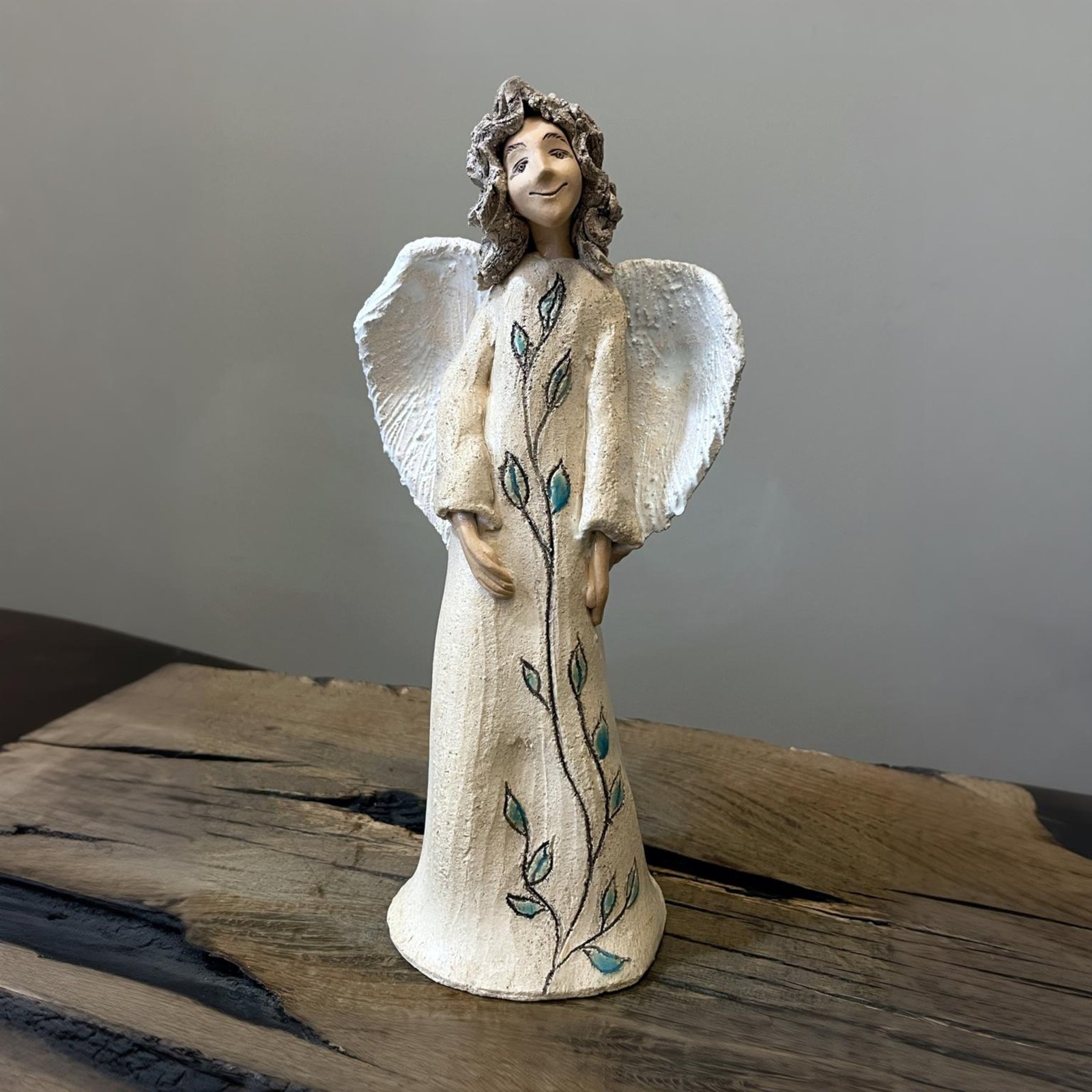 Ceramic white angel sculpture with delicate hand painted leaf design