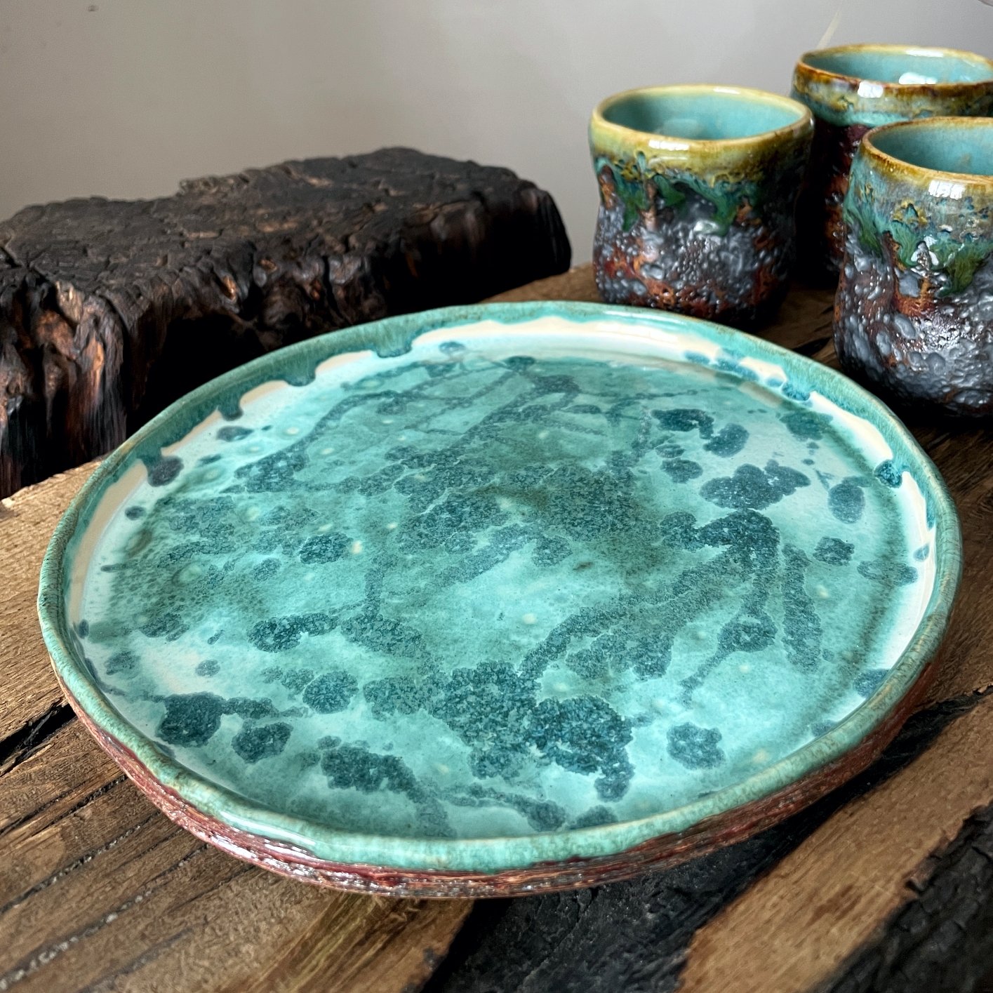 Ceramic serving plate with handmade pottery cups