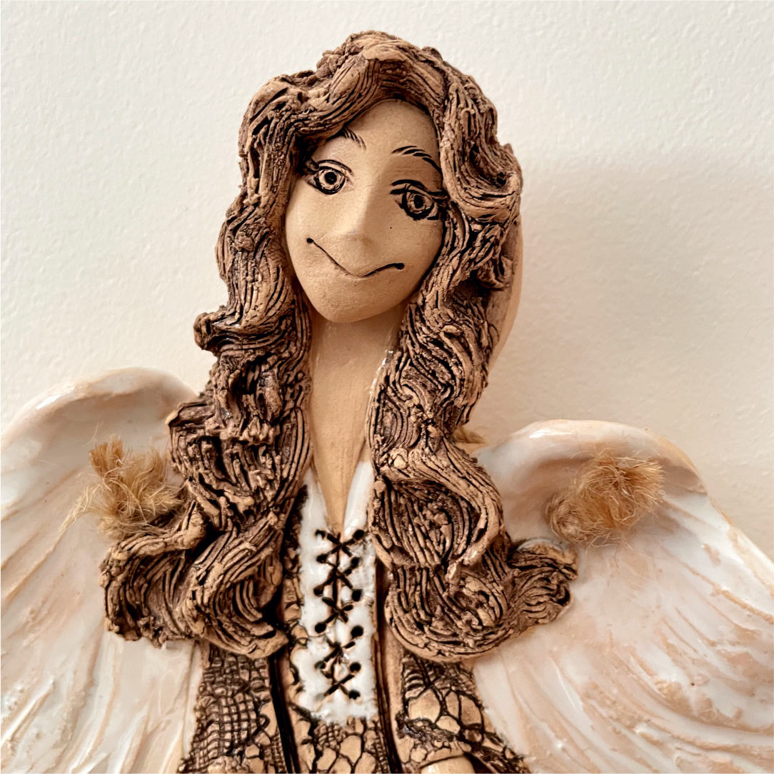 ceramic angel wall sculpture close up