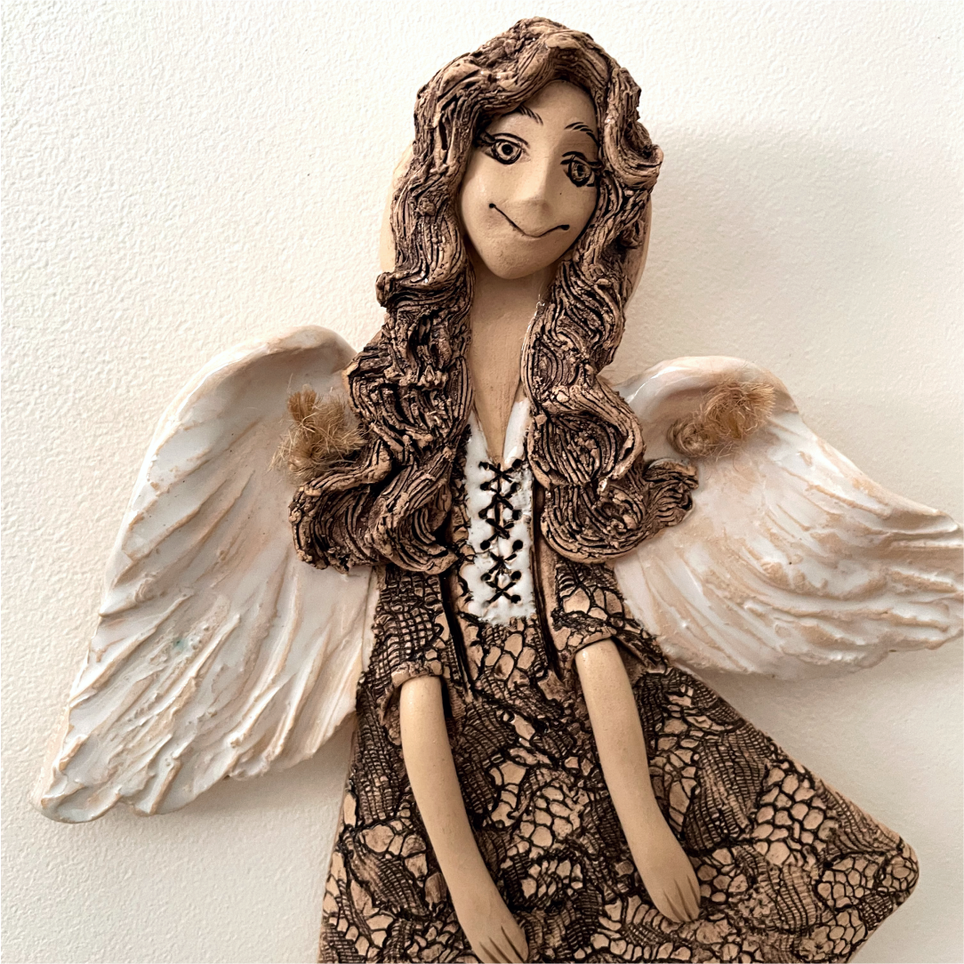 beige ceramic angel wall hanging