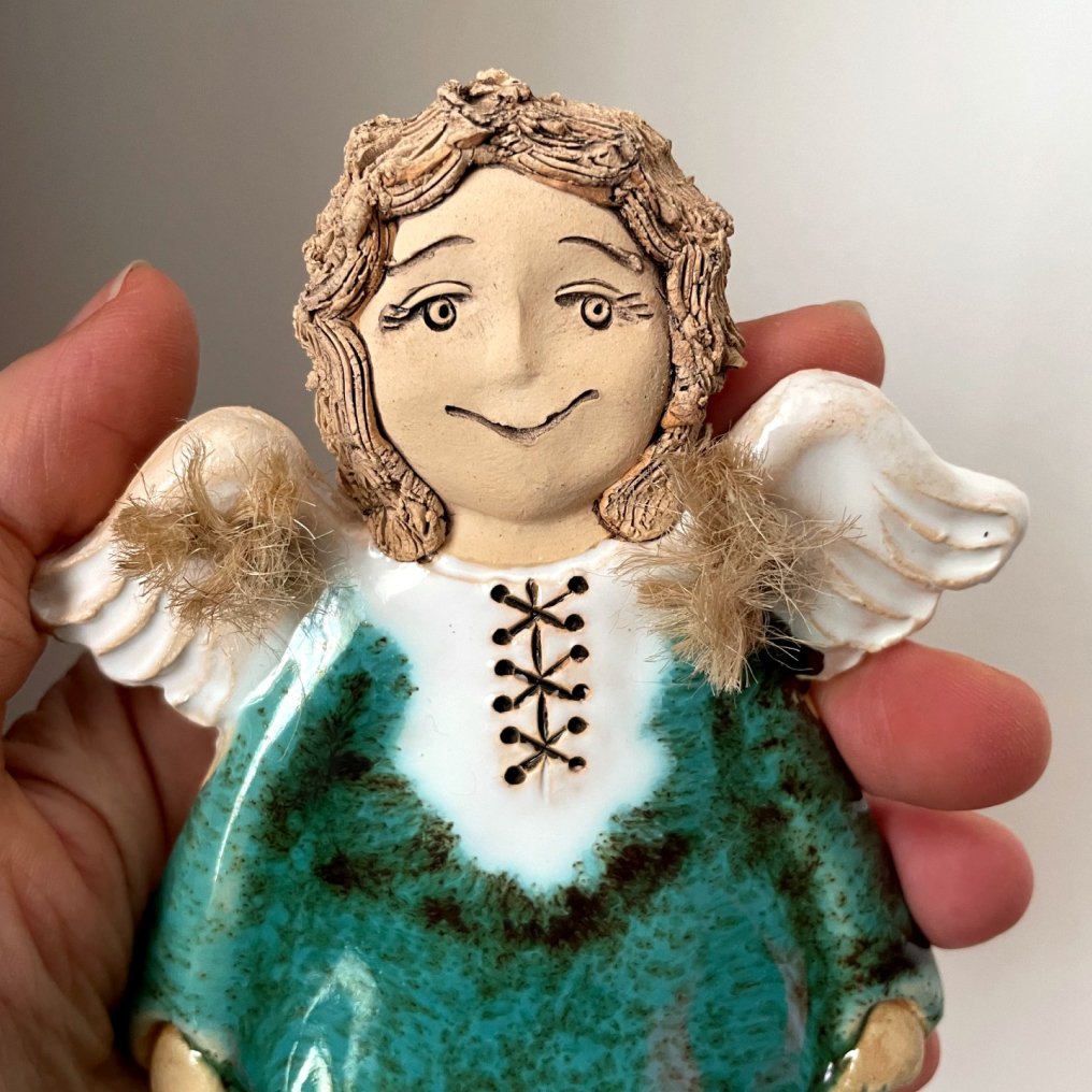 green ceramic angel wall decor close up