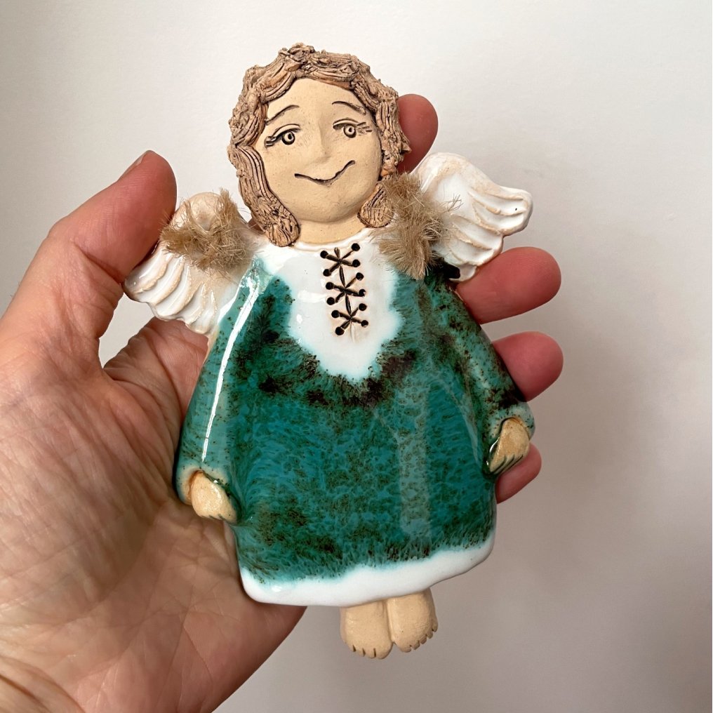 green ceramic angel wall decor front view