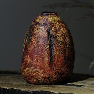 Textured ceramic vase in natural earthy tones, front view
