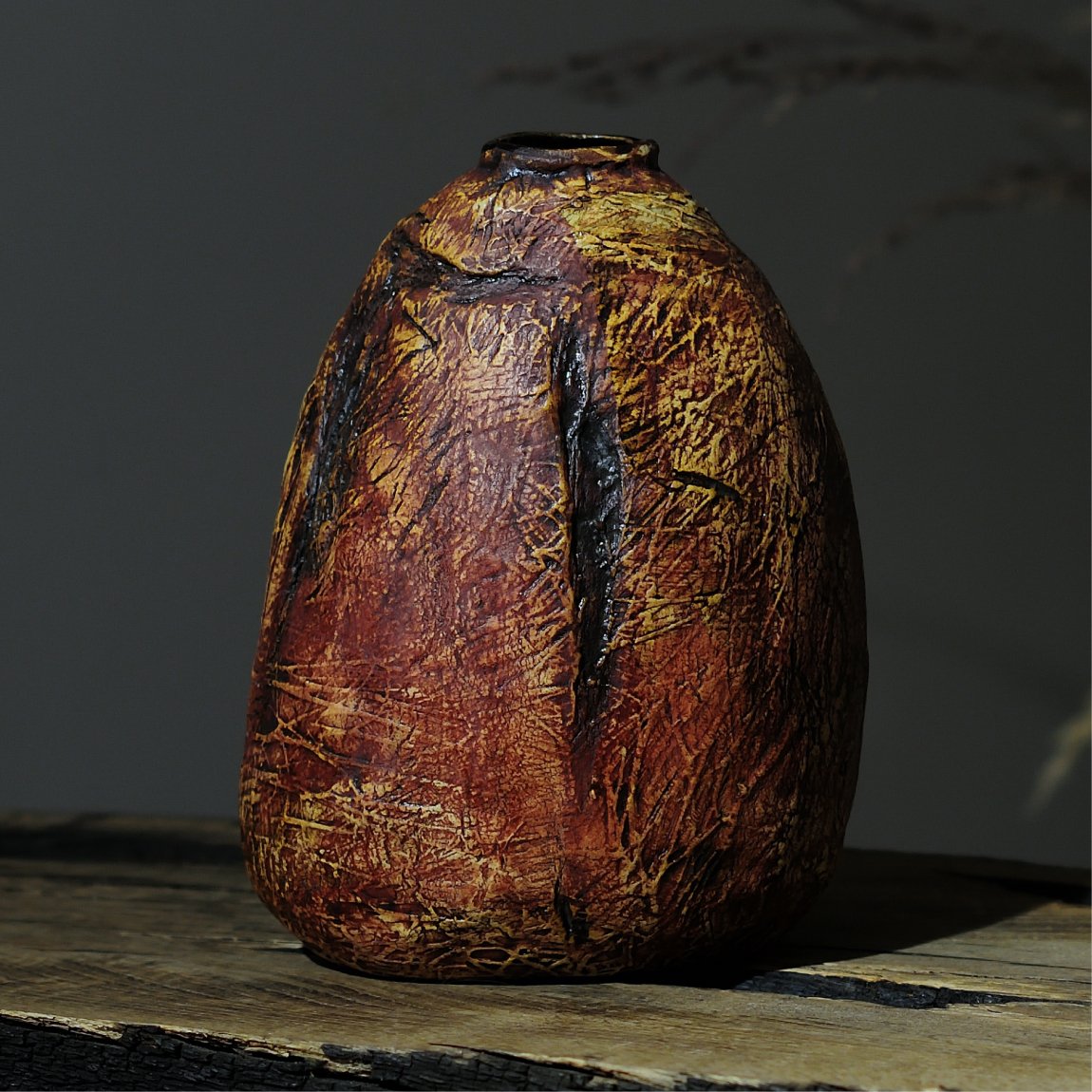 Textured ceramic vase in natural earthy tones, front view