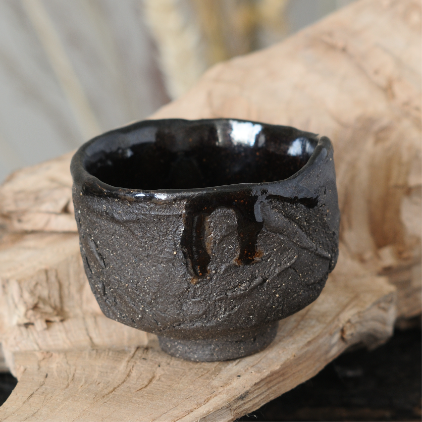 Black stoneware kurinuki guinomi cup for tea and sake