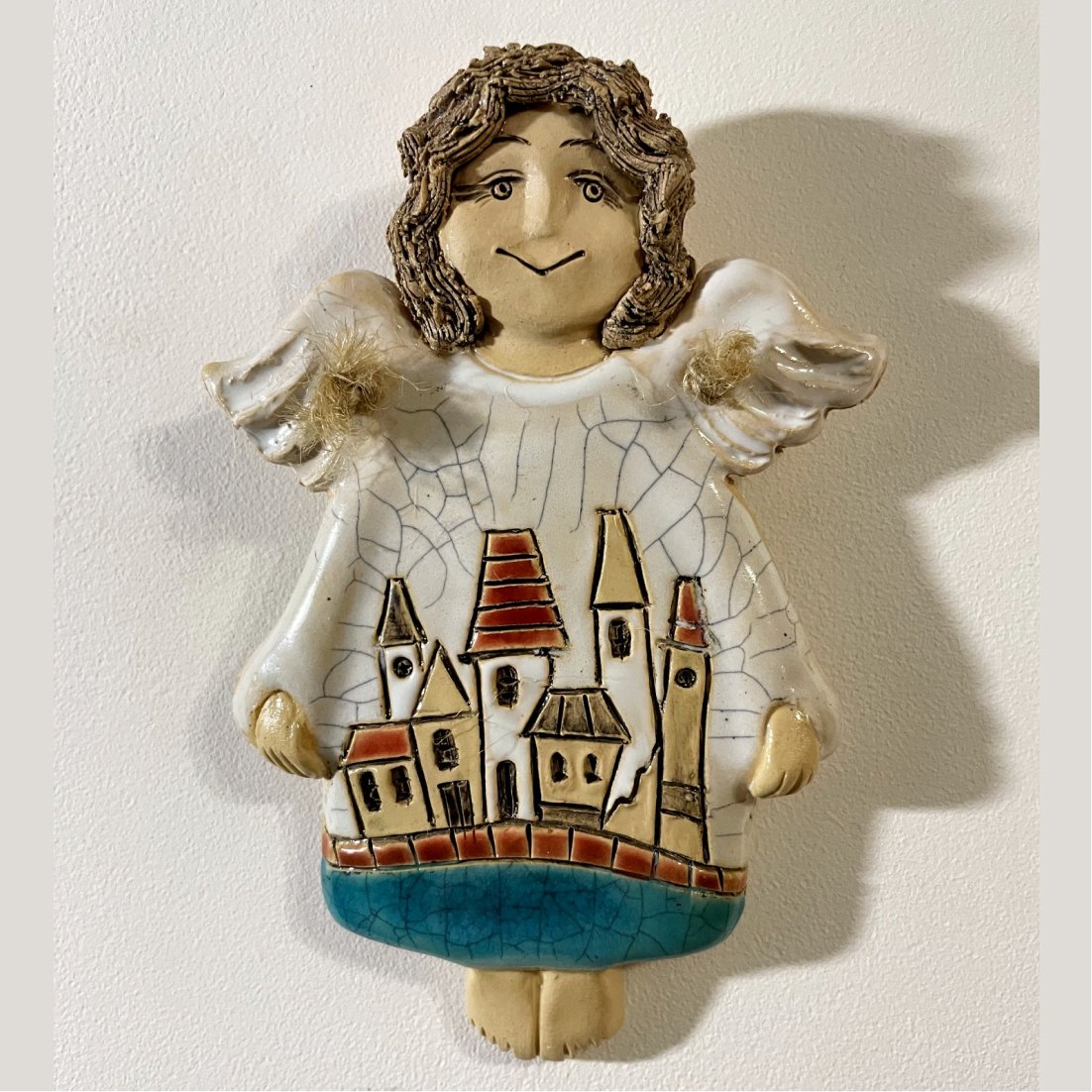 decorative ceramic angel with houses front view