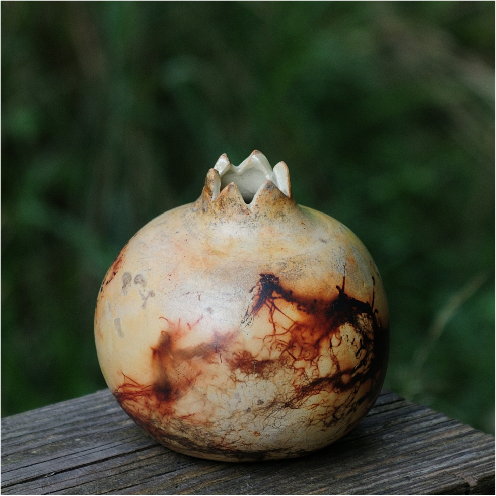 Unique saggar‑fired pomegranate shaped vase with warm earthy tones