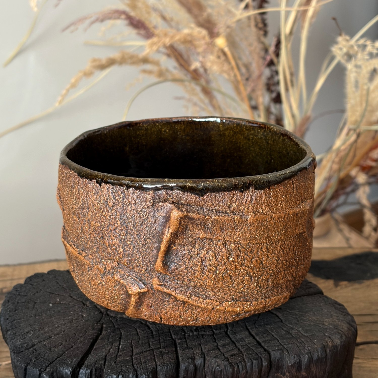 Handmade ceramic matcha bowl with rustic brown textured finish