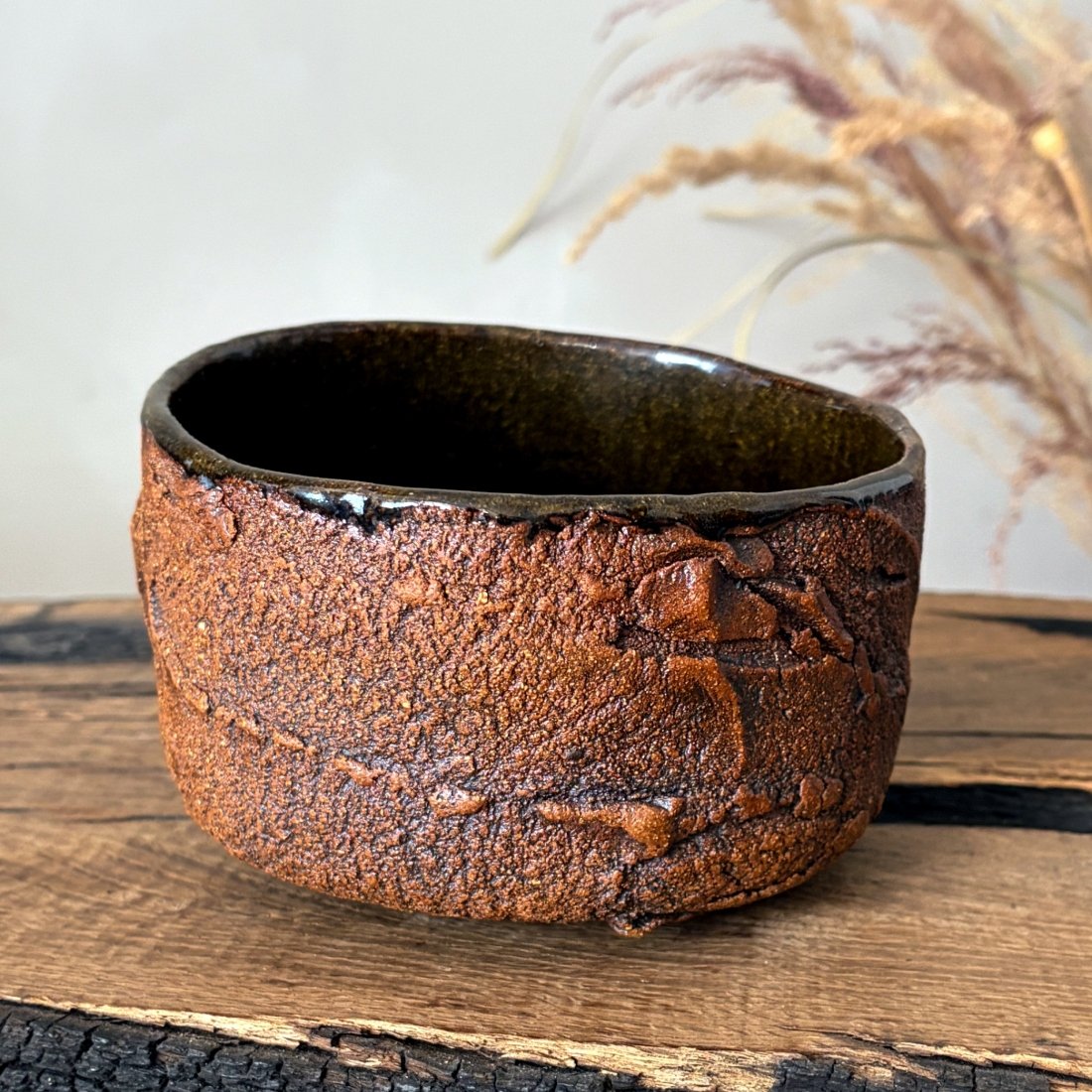 Textured pottery bowl for matcha with dark glazed interior