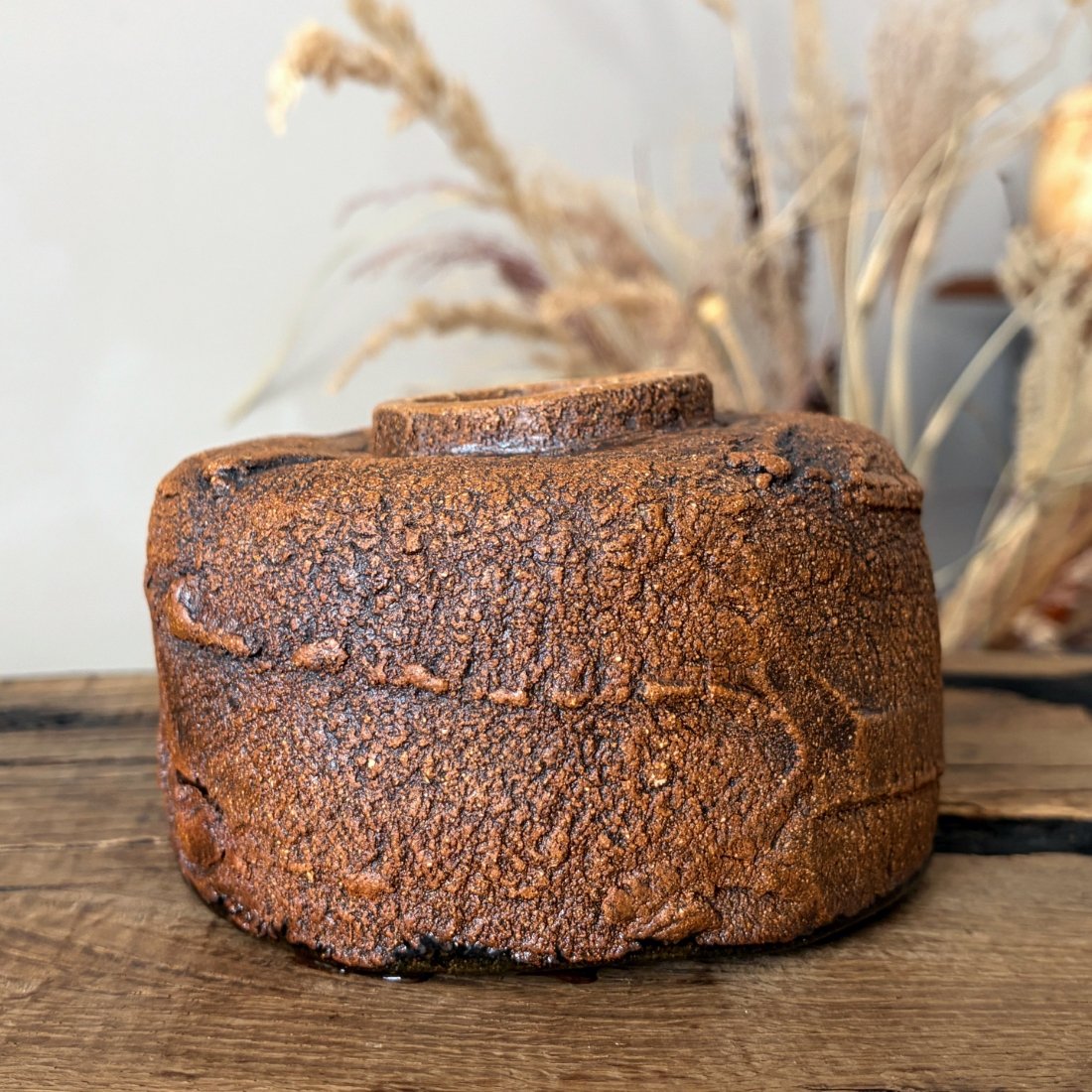 Side view of handcrafted ceramic tea bowl with natural clay texture