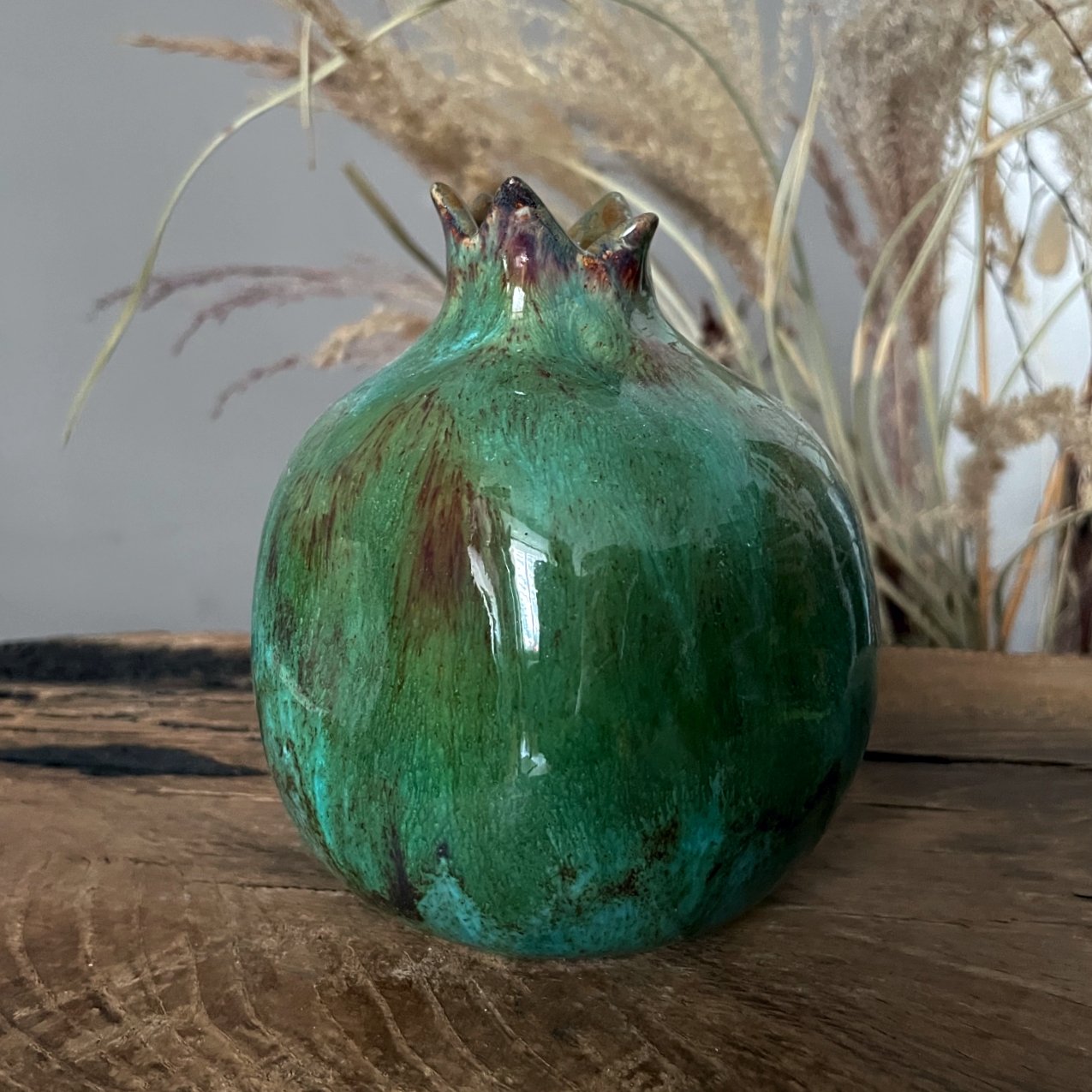 Ceramic pomegranate figurine with glossy green glaze