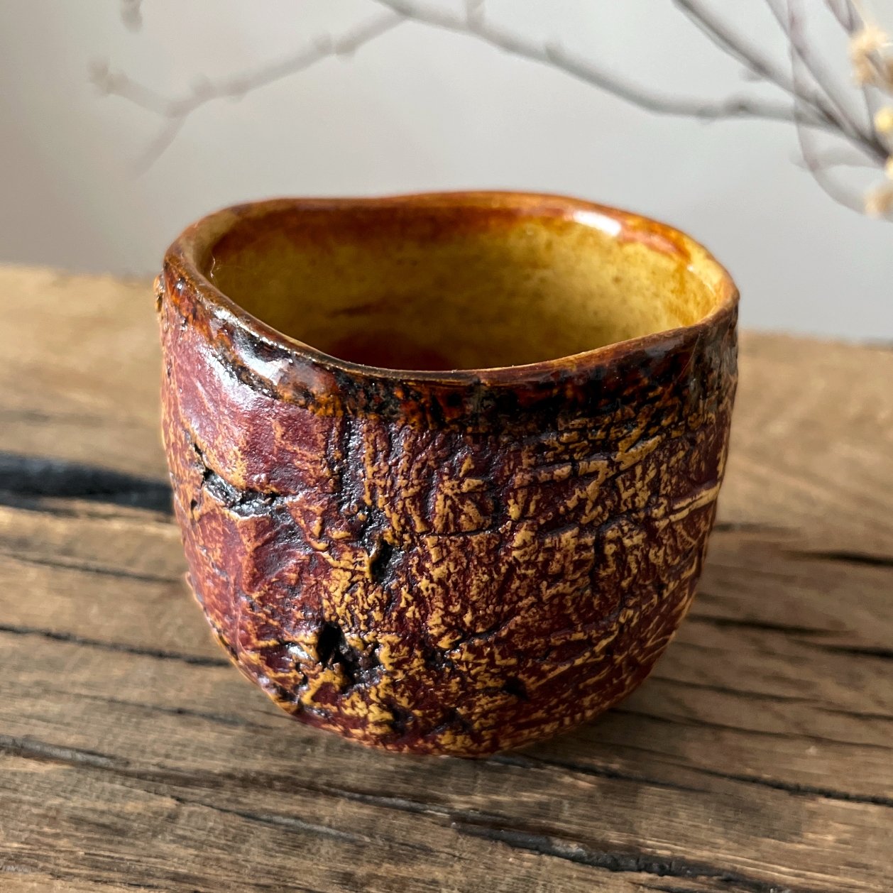 Detailed view of carved textured pottery tea cup