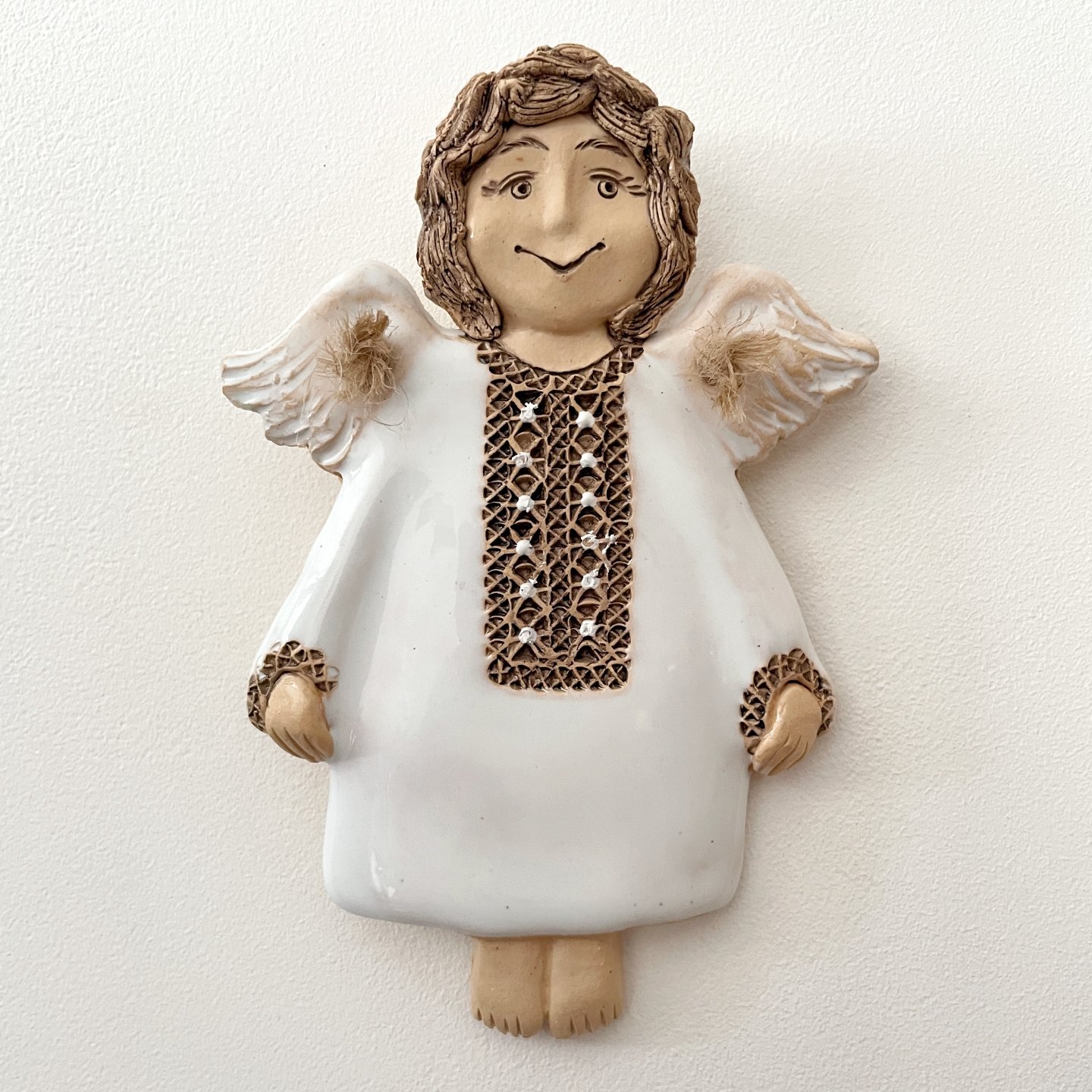 Decorative ceramic angel wall hanging in white glaze