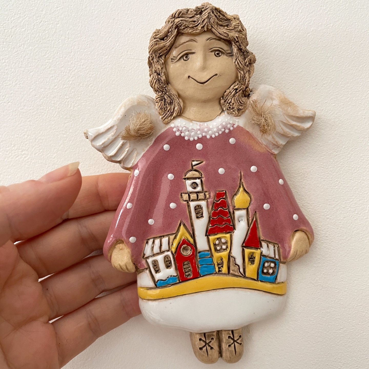 Ceramic angel with colorful village motif