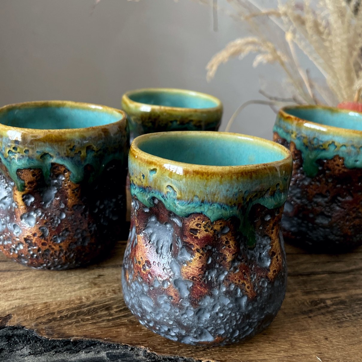 Handmade clay coffee and tea cups with turquoise glazed interior
