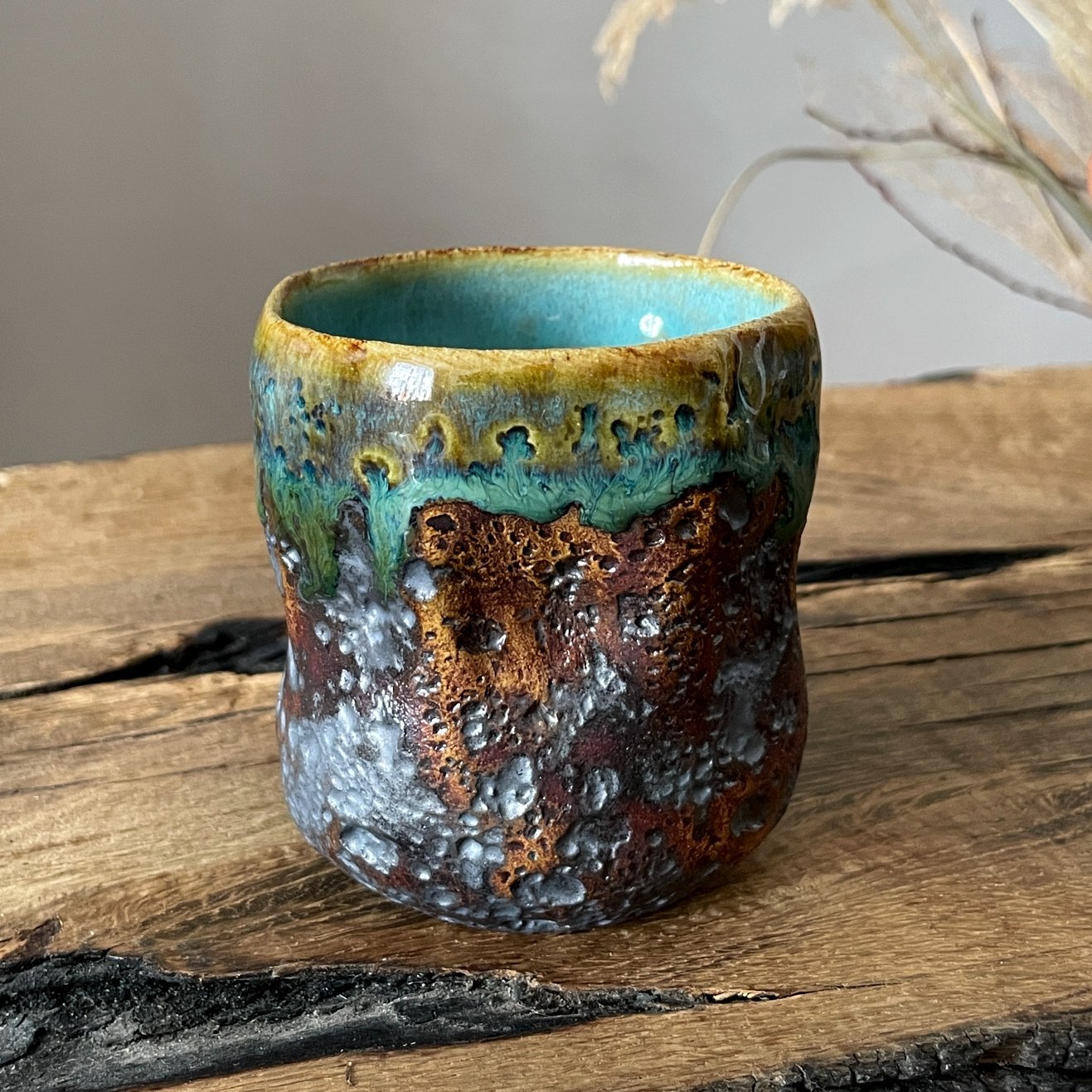 Handmade ceramic coffee cup with textured surface
