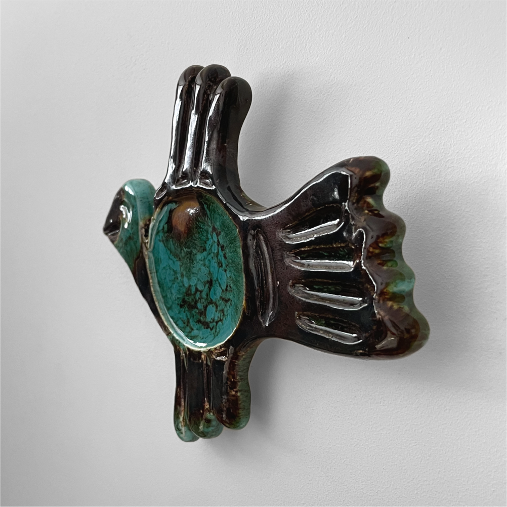 Ceramic bird wall sculpture close-up