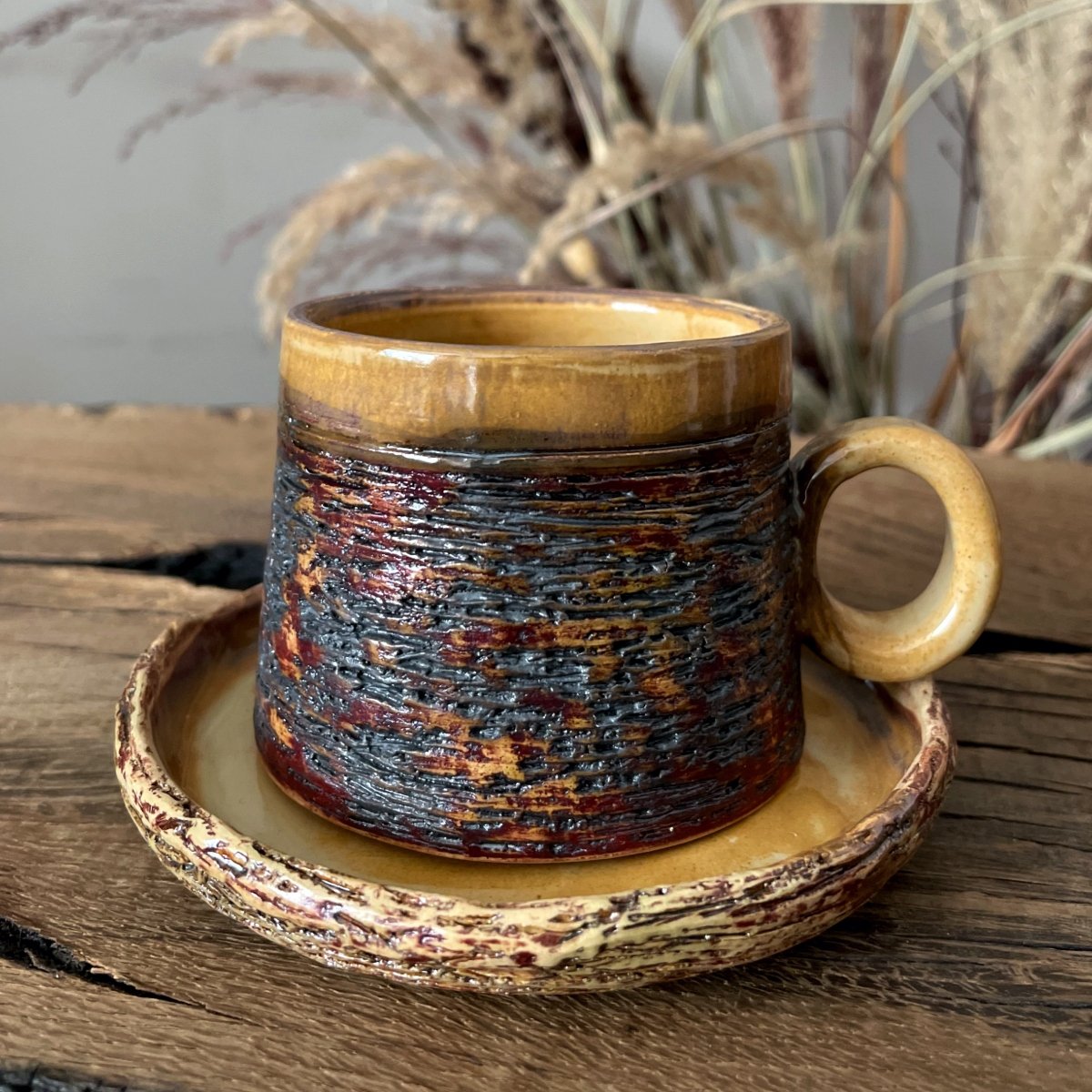 Artisan espresso cup with saucer on wooden table