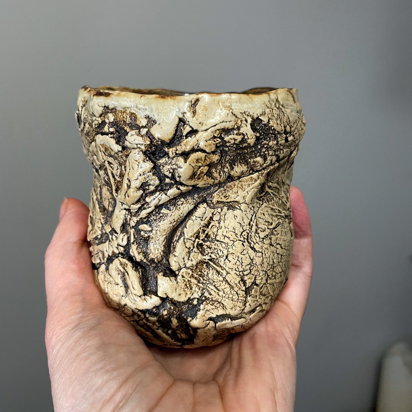 ceramic cup in hand textured clay surface