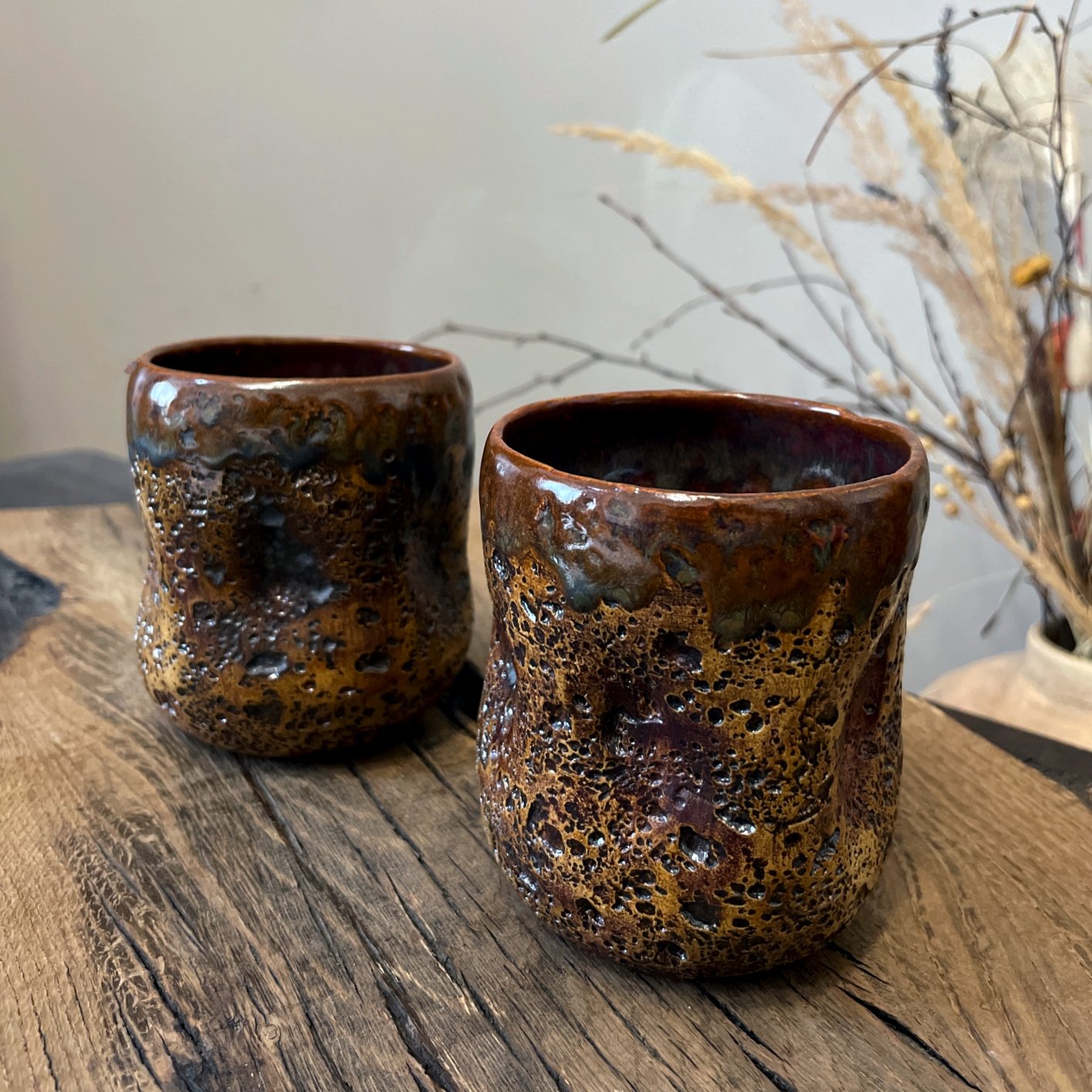Textured stoneware yunomi cup with brown and black glaze close-up