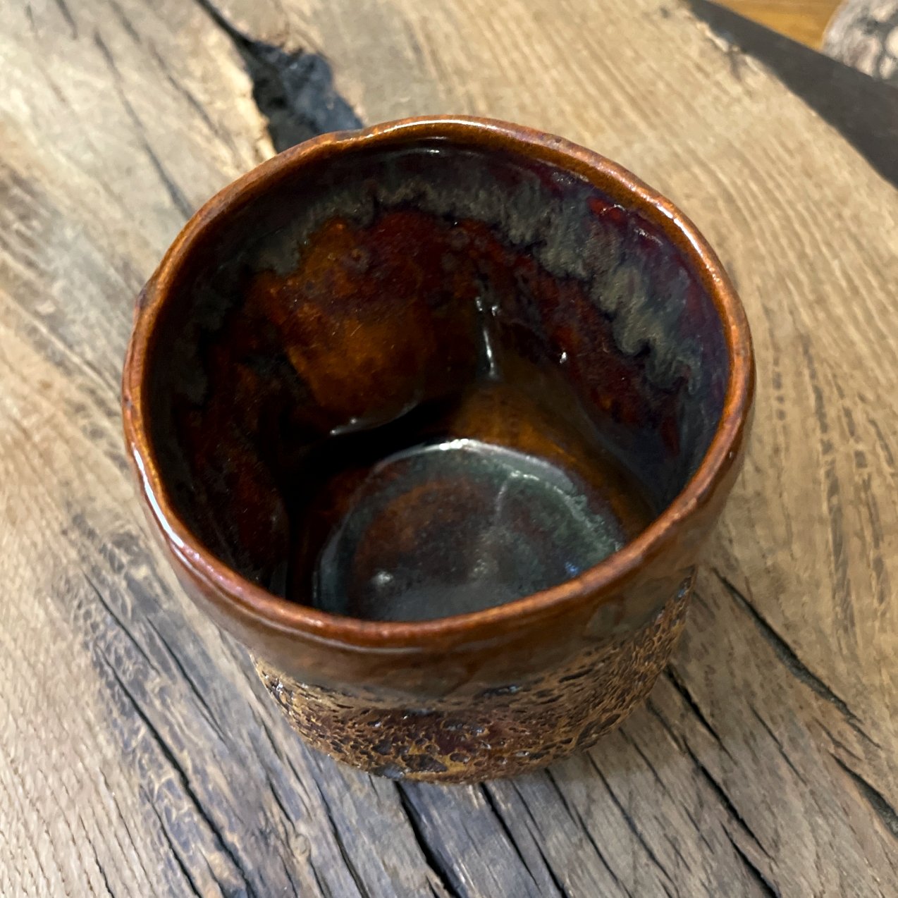Artisan ceramic tea cup with textured stoneware glaze and organic shape