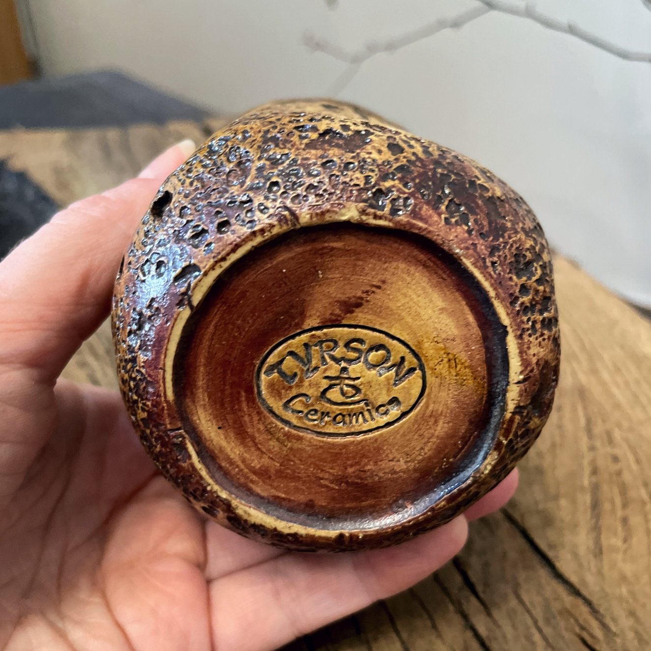 Rustic pottery yunomi cup photographed on reclaimed wood surface