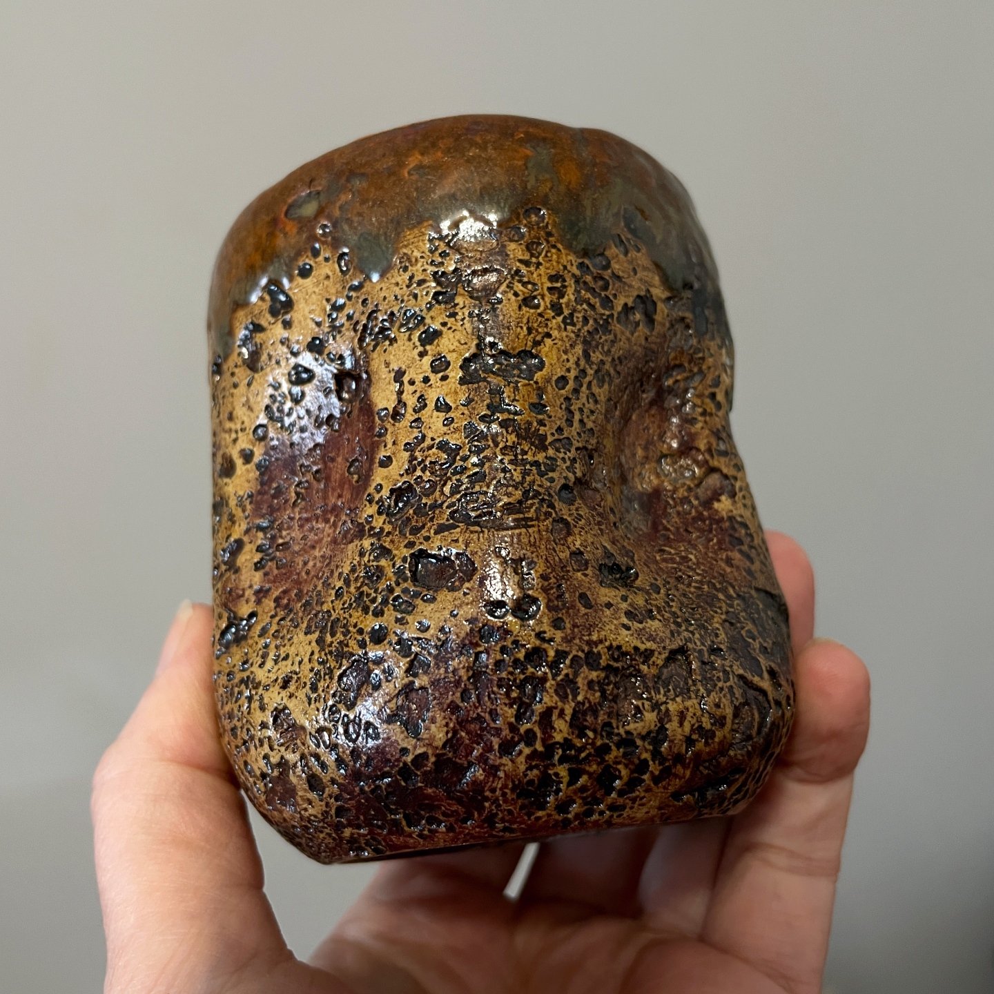 Handmade ceramic tumbler with earthy brown lava glaze details