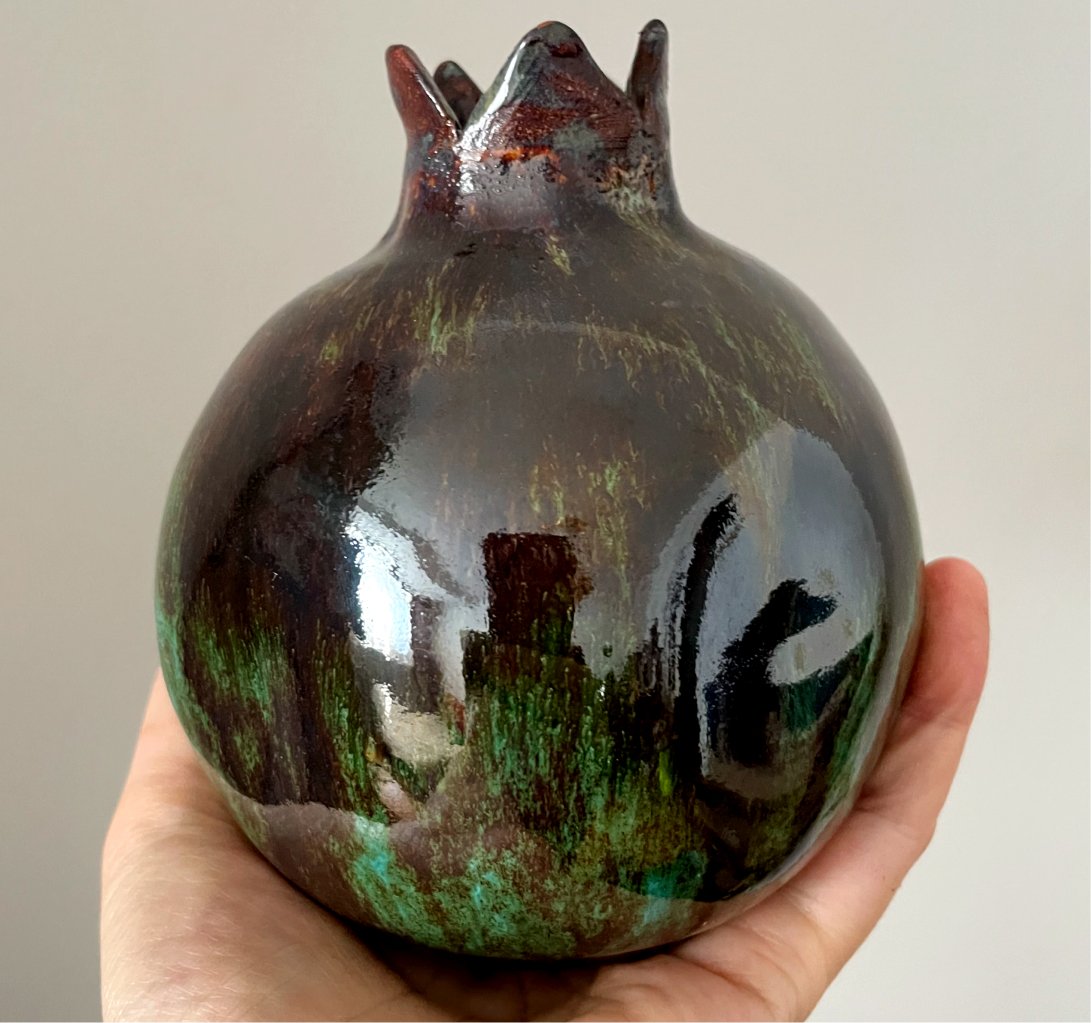 Dark green ceramic pomegranate art object