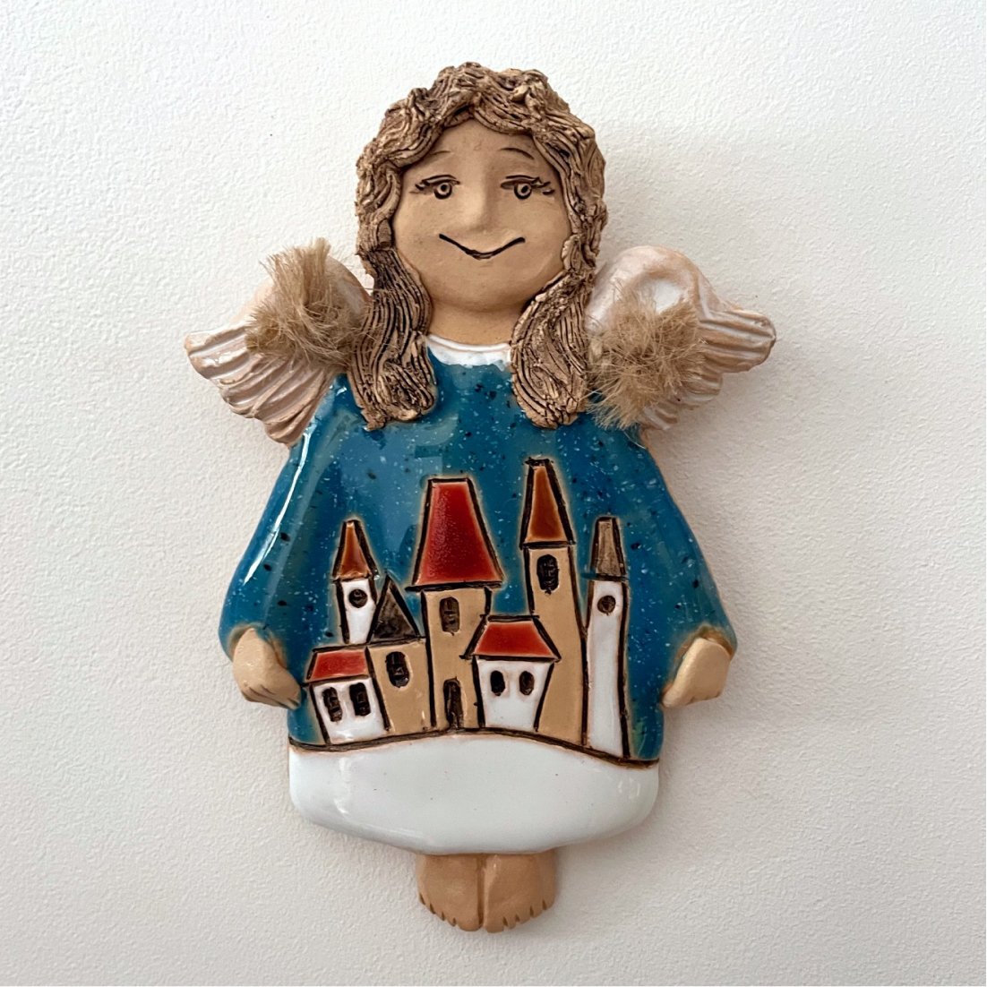 handmade ceramic angel with house decoration