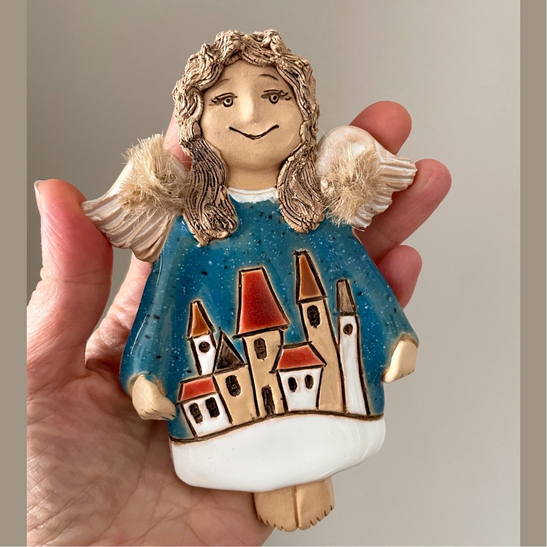 ceramic angel ornament with houses