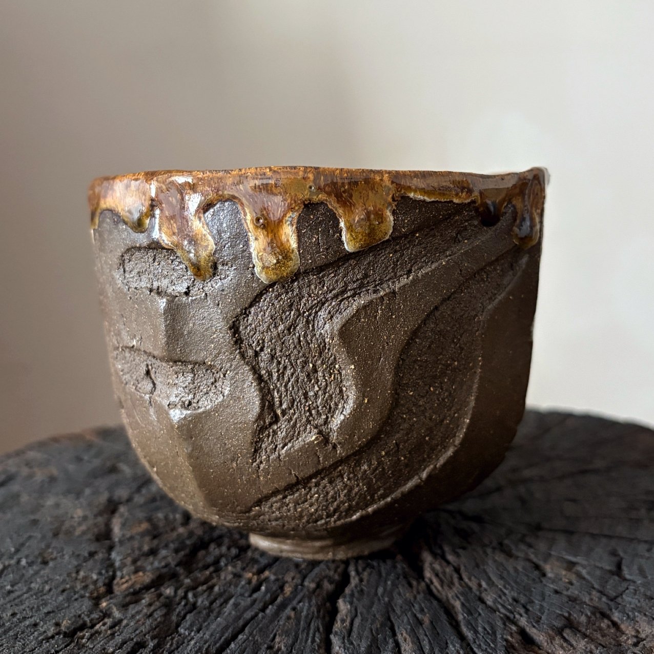 Textured handmade Kurinuki tea bowl from black clay