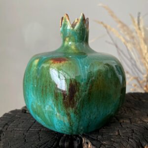Decorative ceramic pomegranate sculpture with crown detail