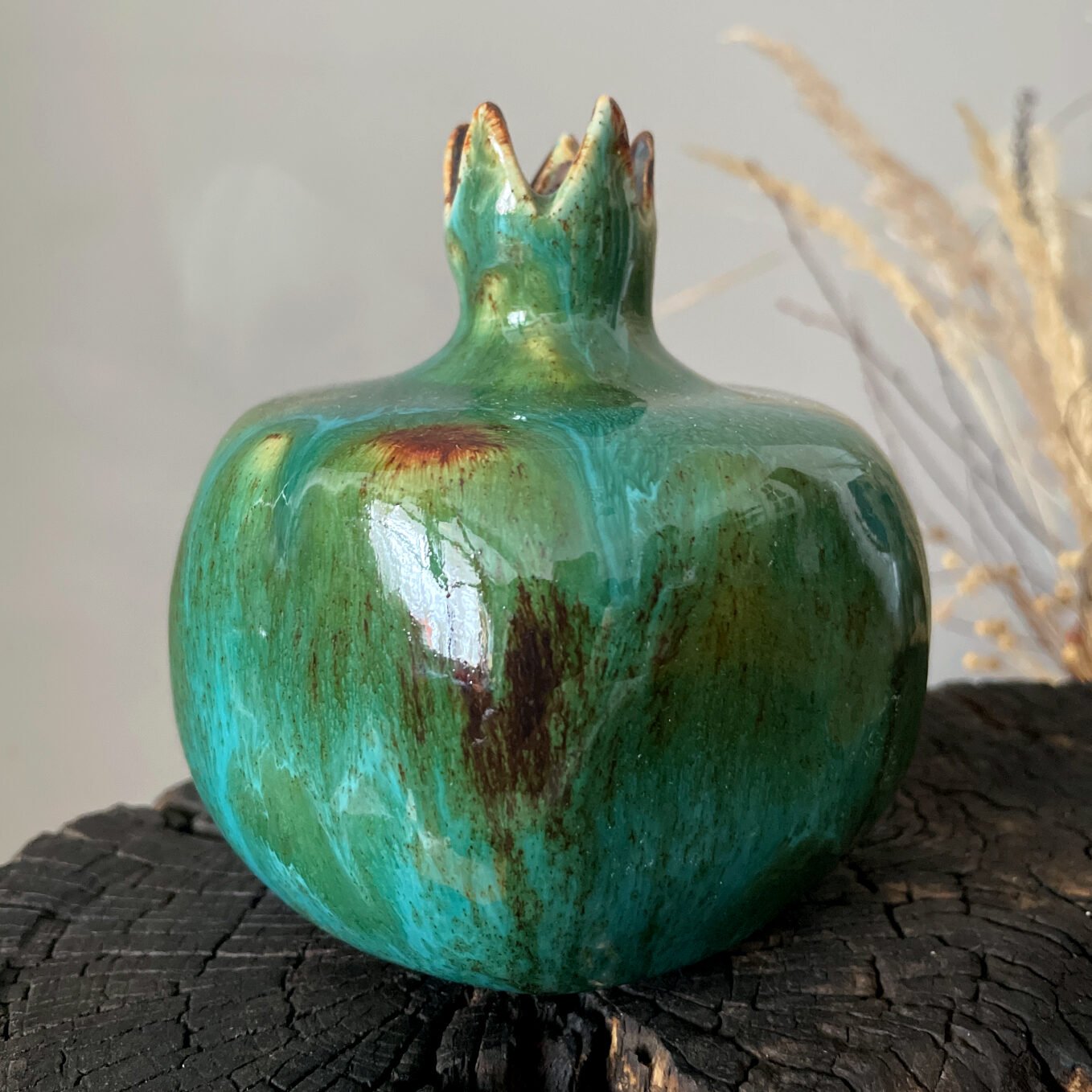Decorative ceramic pomegranate sculpture with crown detail