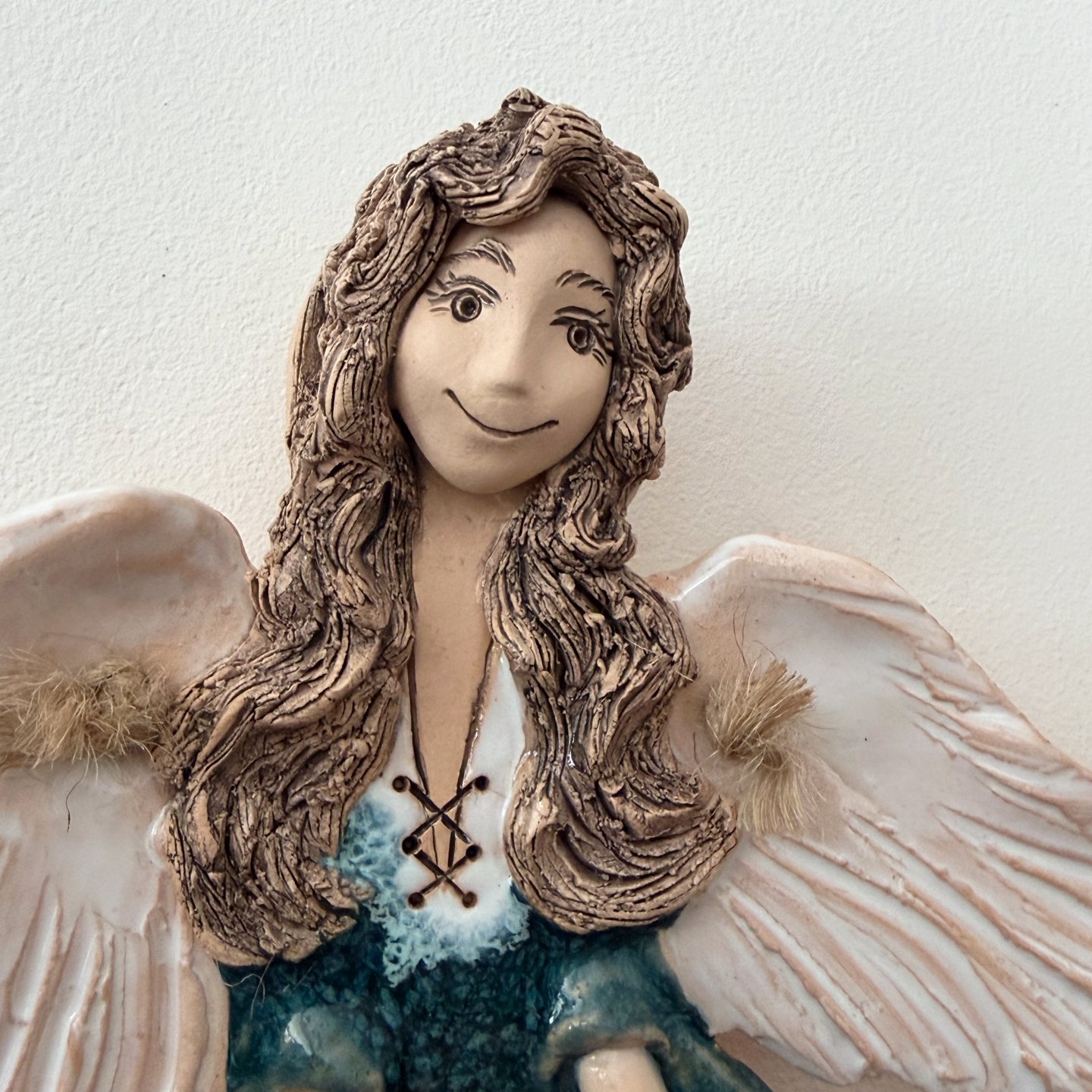 Close-up of handmade ceramic angel face