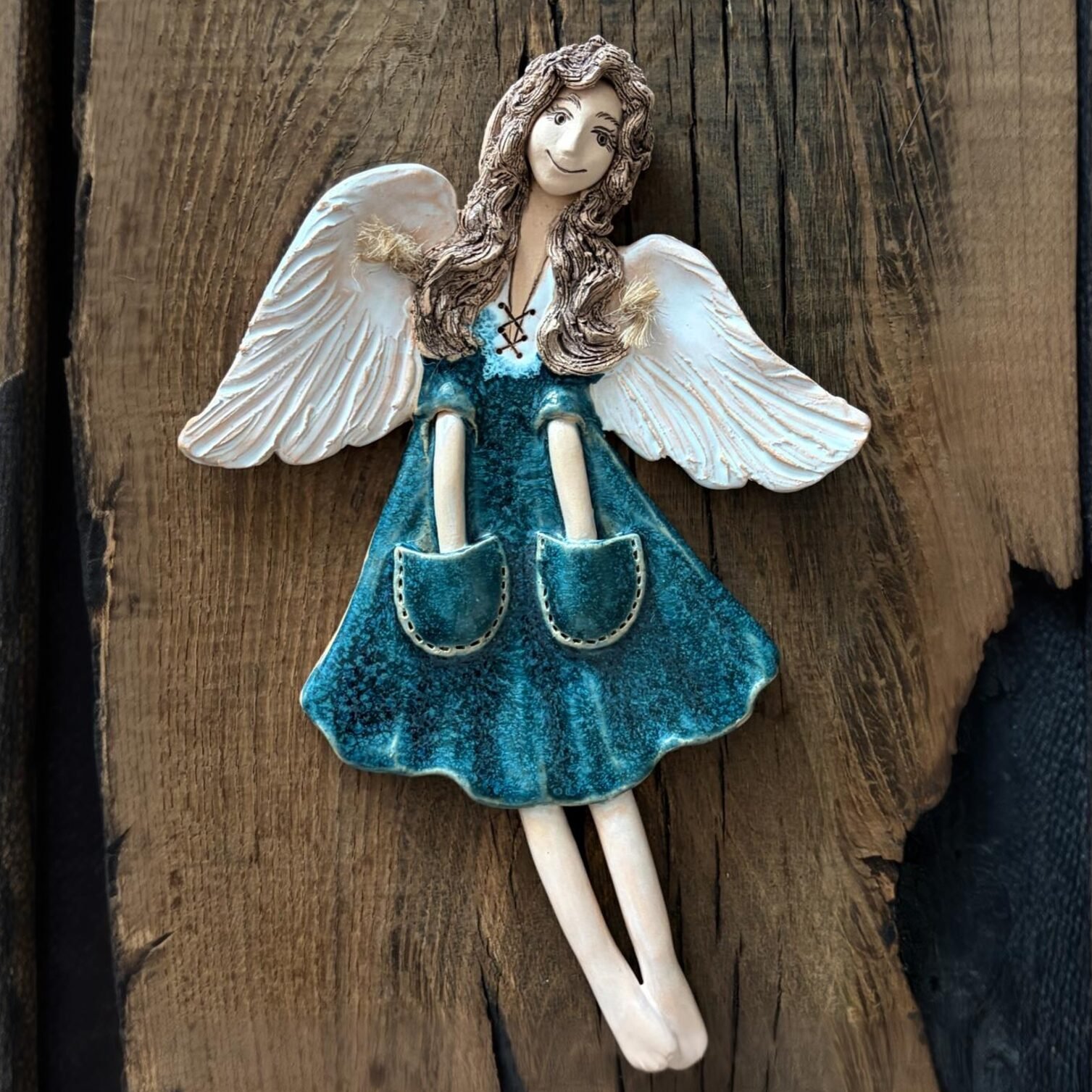 Front view of handmade ceramic angel with outstretched wings