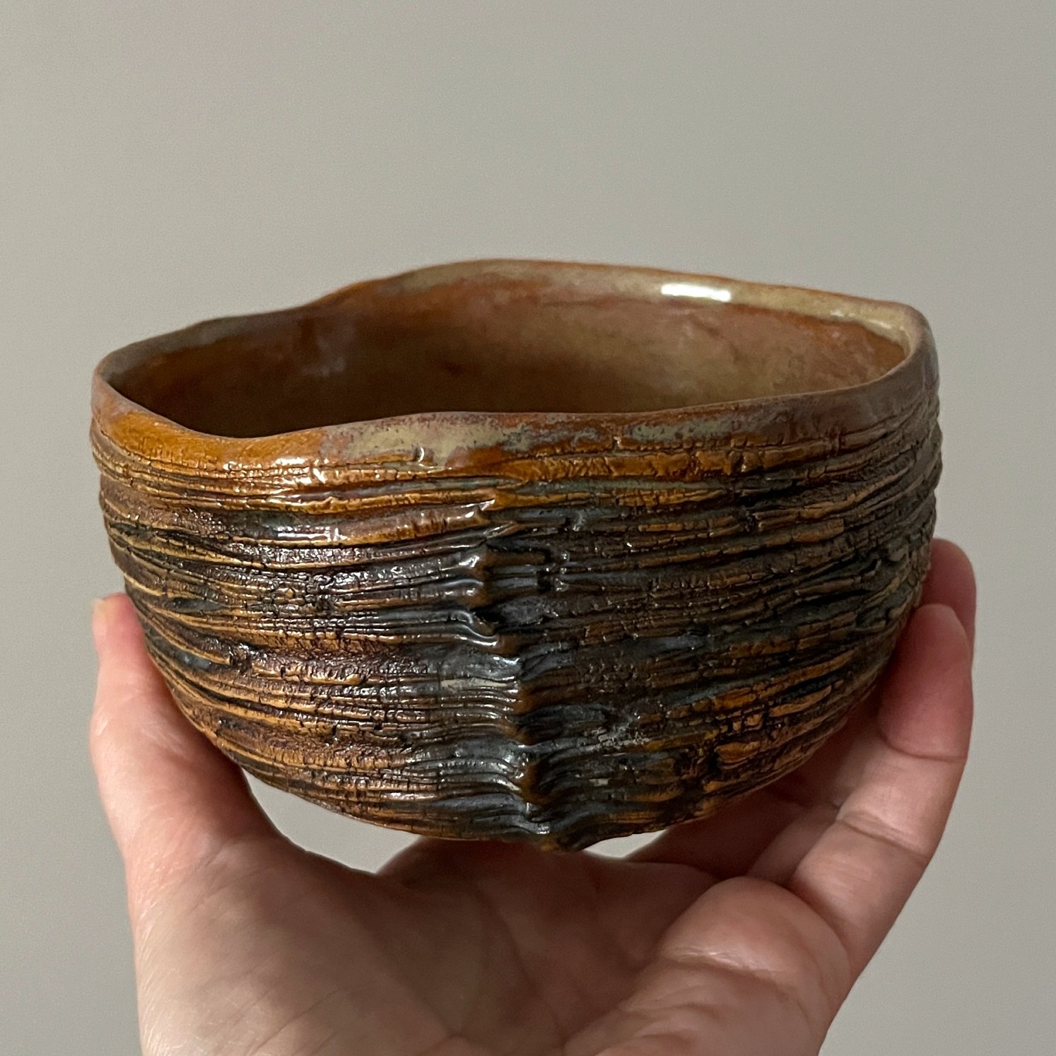 Handmade chawan matcha bowl held in hand for size reference
