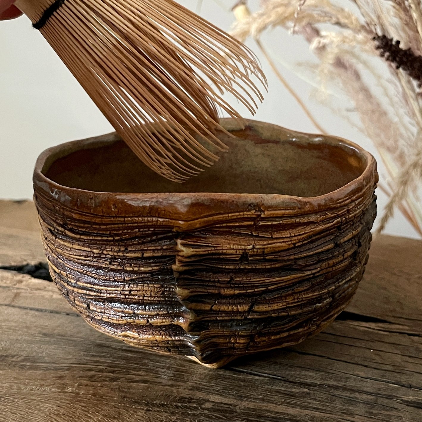 Handmade ceramic chawan with bamboo matcha whisk