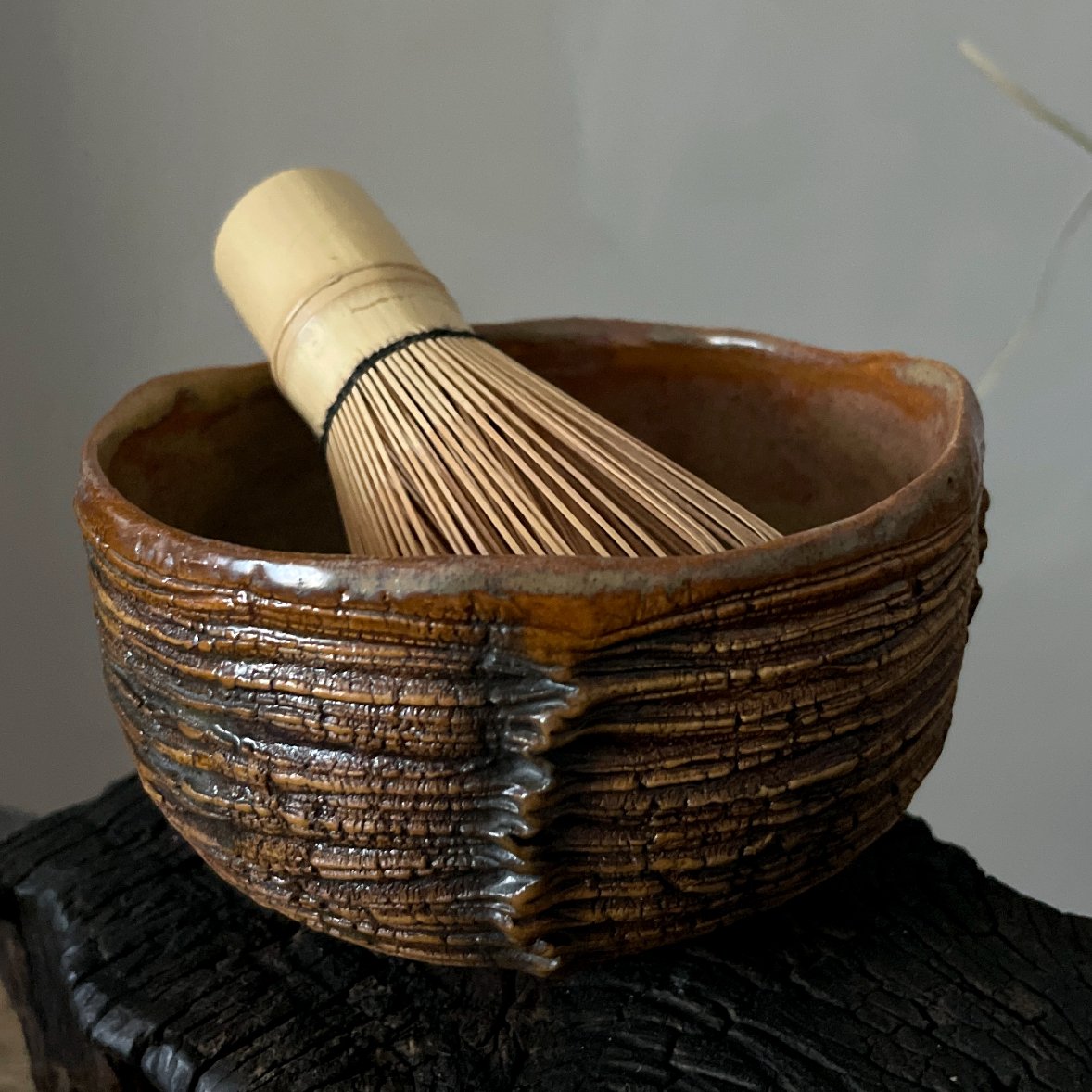 Handmade ceramic matcha bowl with textured carved surface