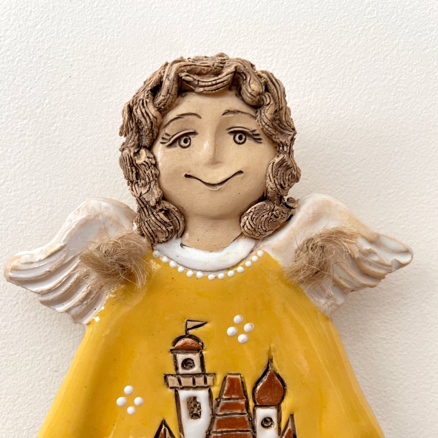 Smiling ceramic angel wall decor with yellow glaze