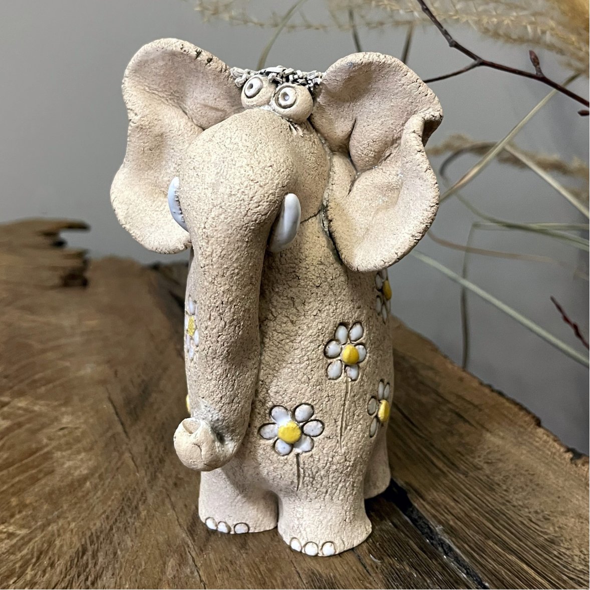 Ceramic elephant sculpture with hand-painted floral details