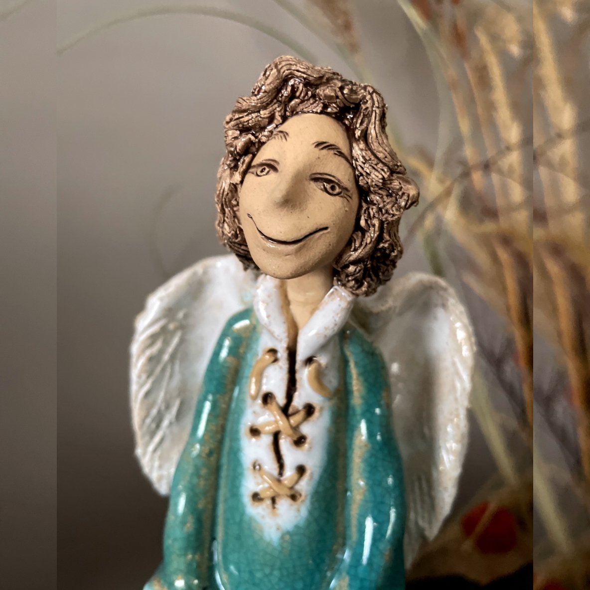 Handmade stoneware angel sculpture, side view