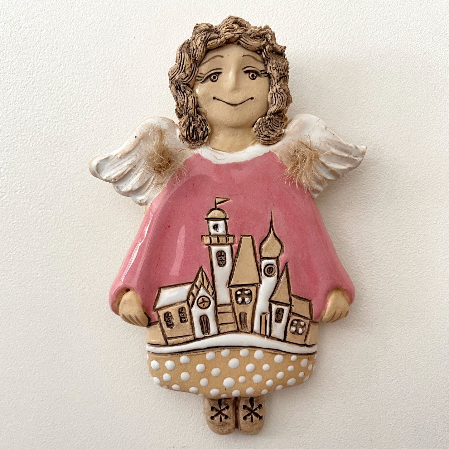 Handmade angel wall decor in pink dress holding small houses