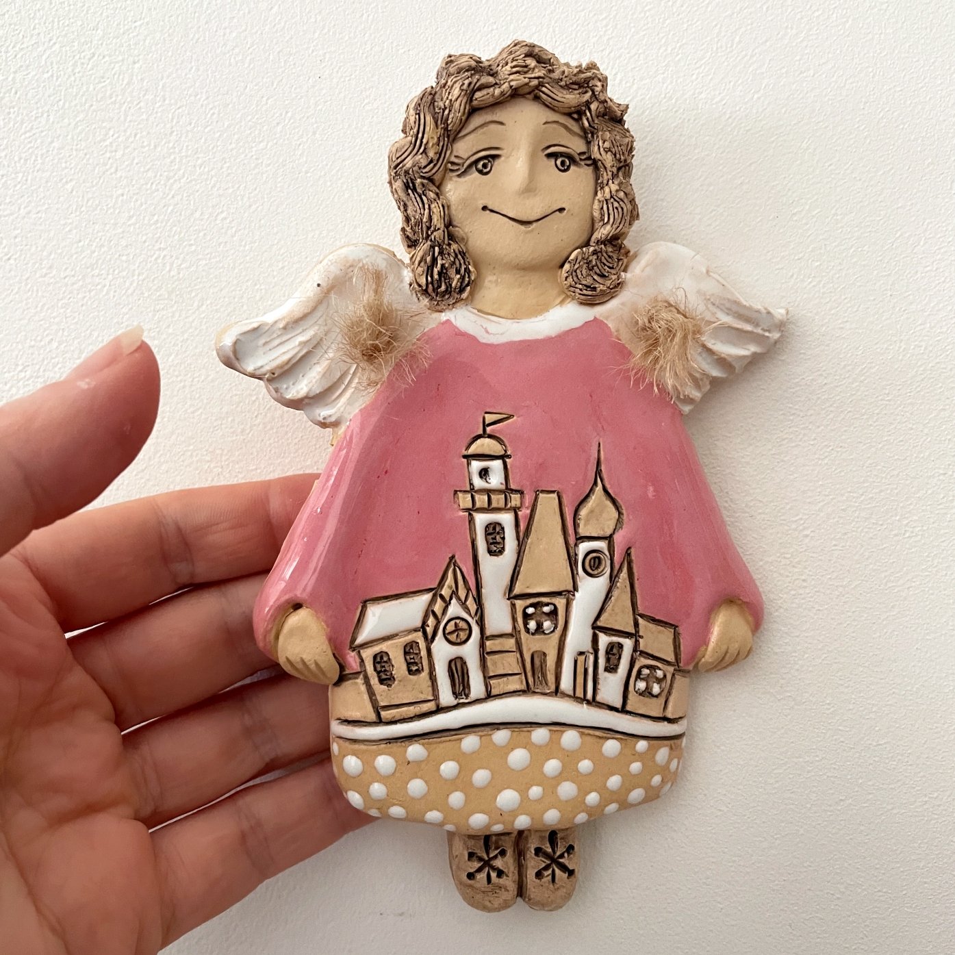 Decorative ceramic angel wall hanging with painted townscape
