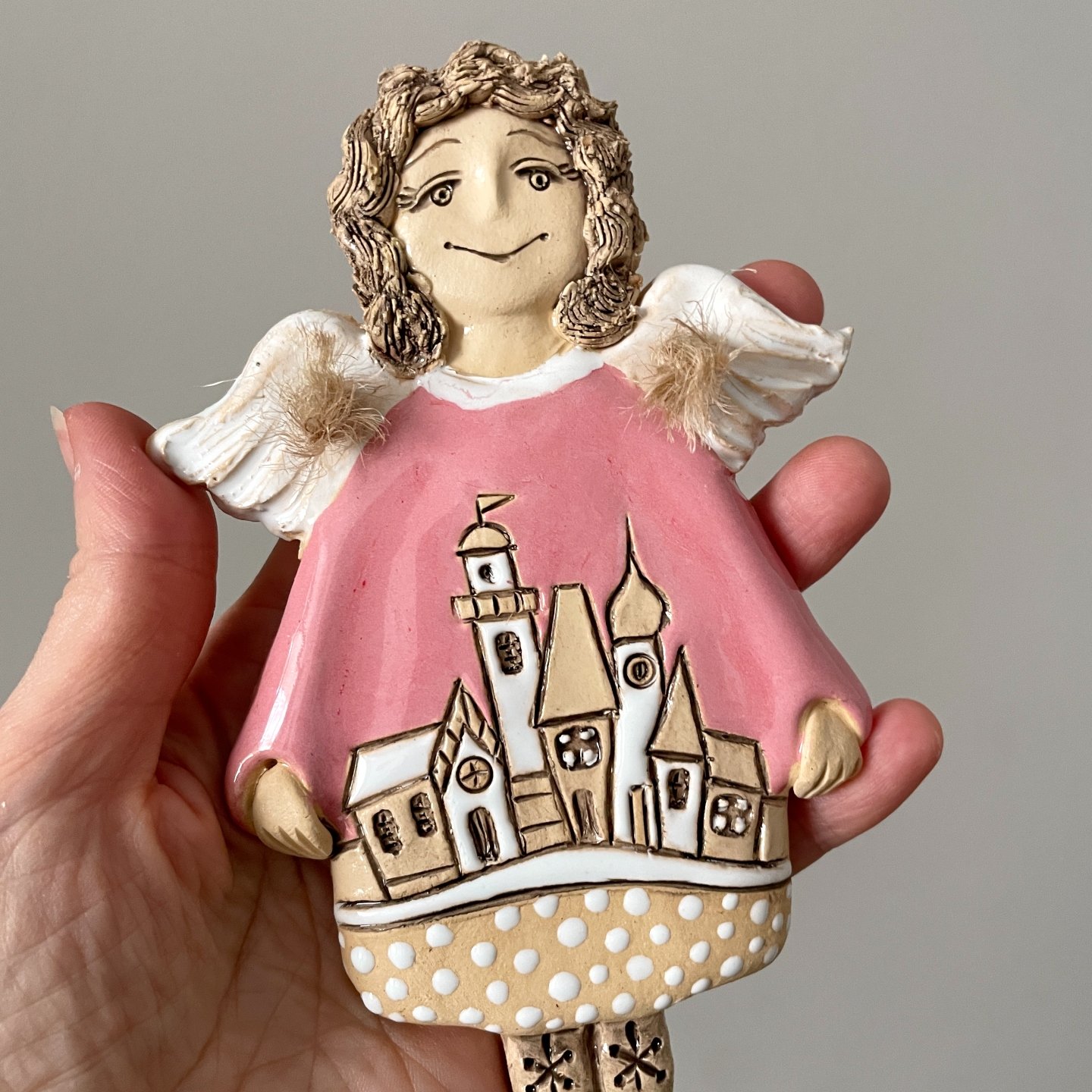 Ceramic angel wall hanging with miniature village design