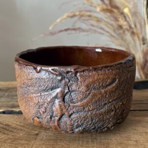 Handmade ceramic tea bowl with Kurinuki textured exterior
